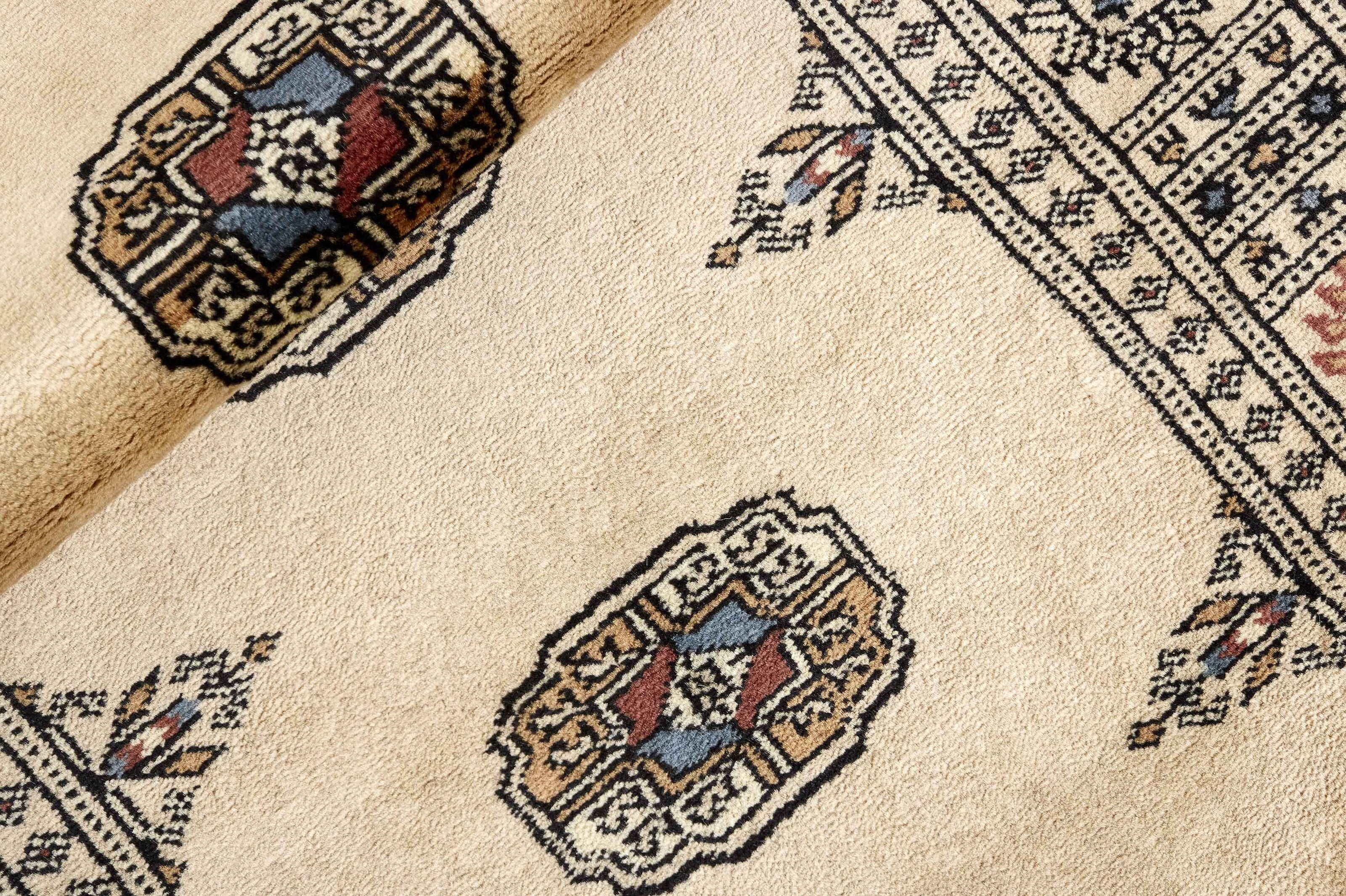 Beige Oriental runner with traditional bordered pattern