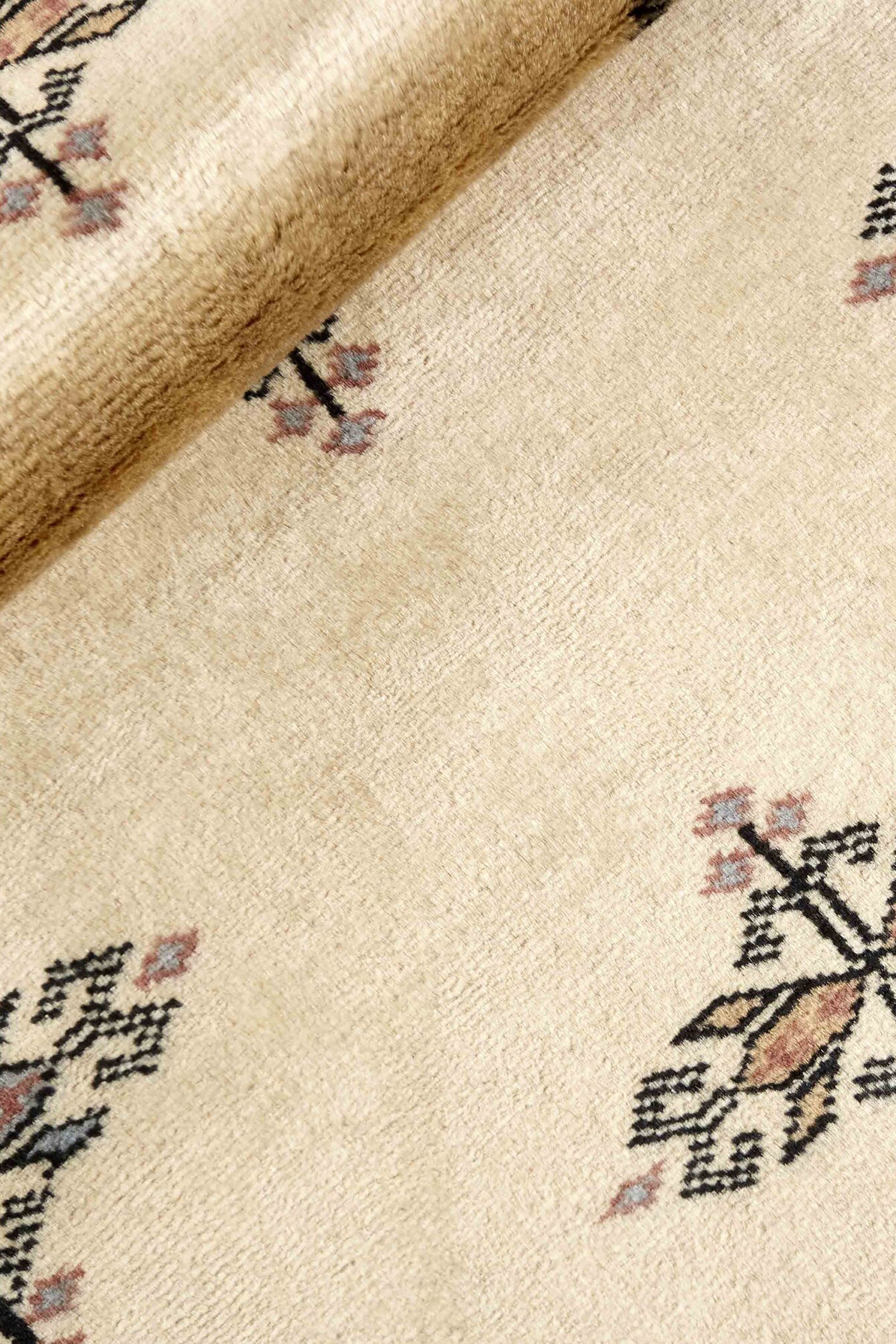 Beige Oriental runner with traditional bordered pattern