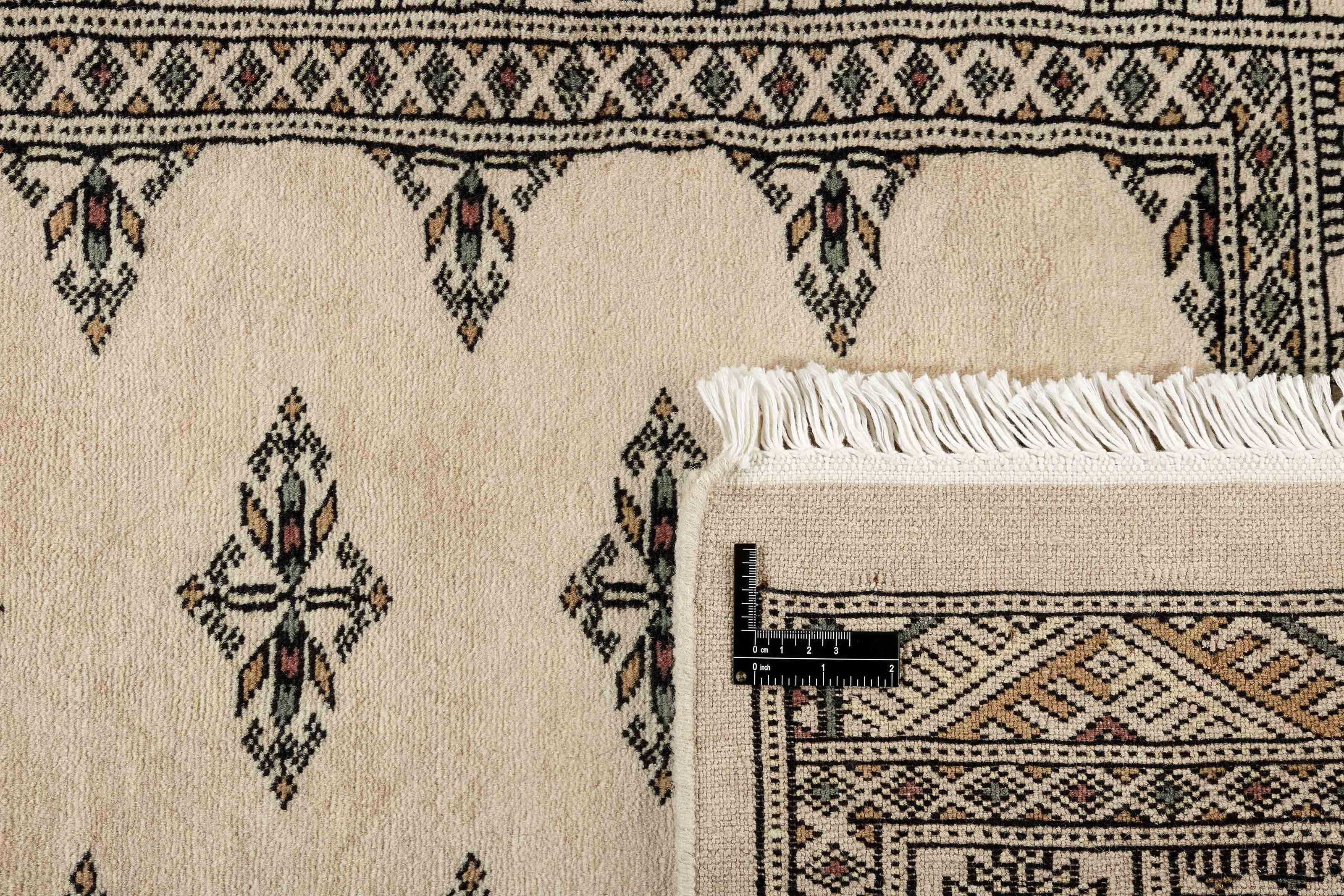 Beige Oriental runner with traditional bordered pattern