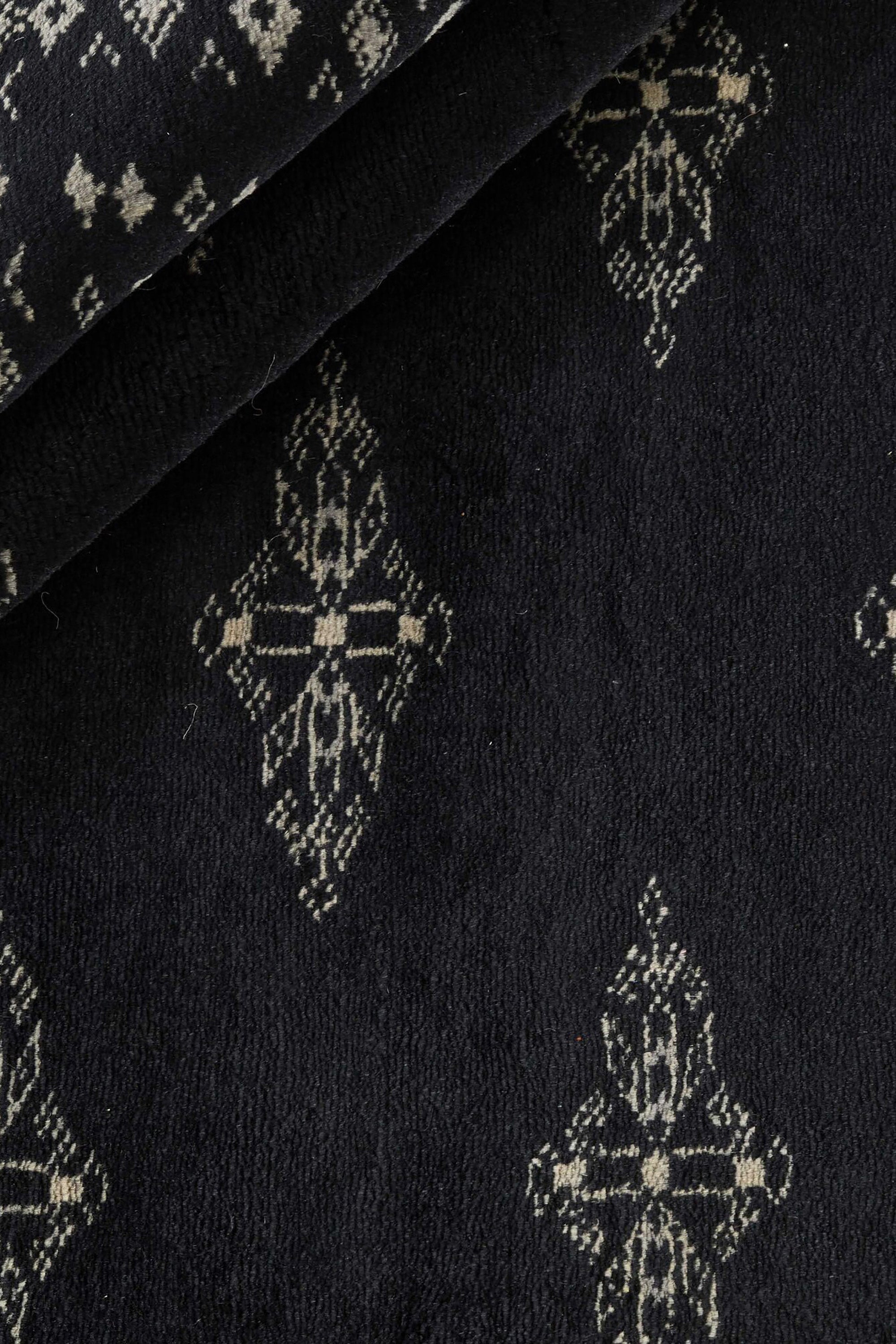 Black Oriental runner with traditional bordered pattern