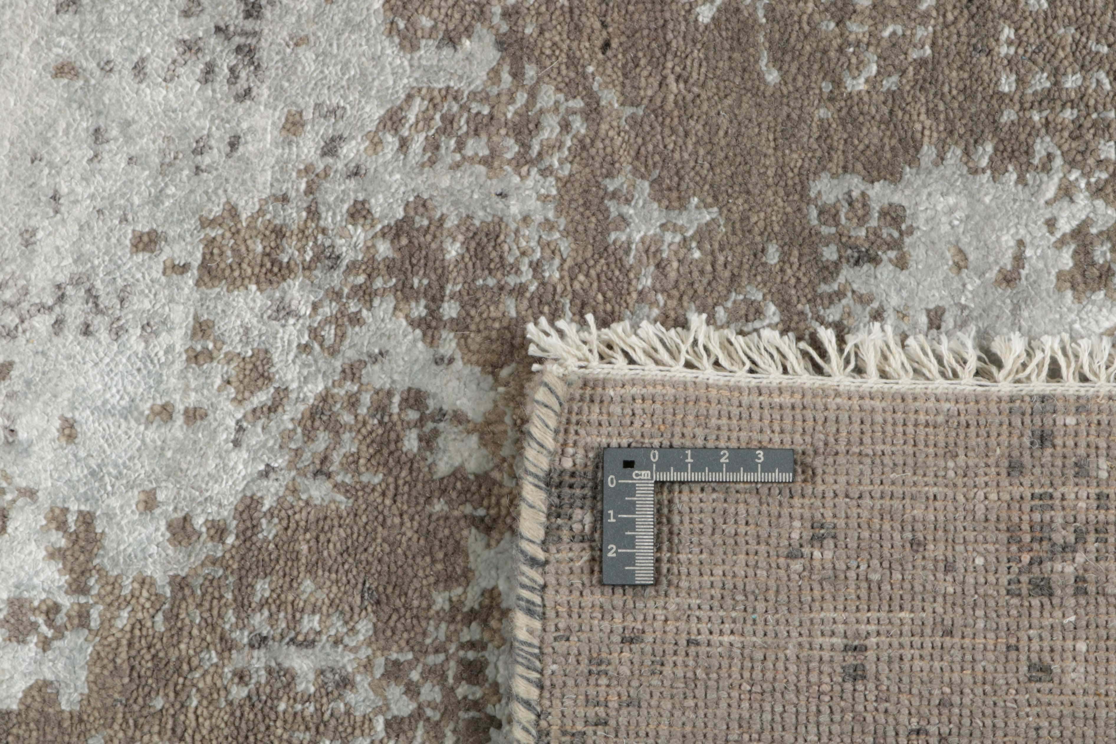 Large area rug with abstract design in grey and taupe