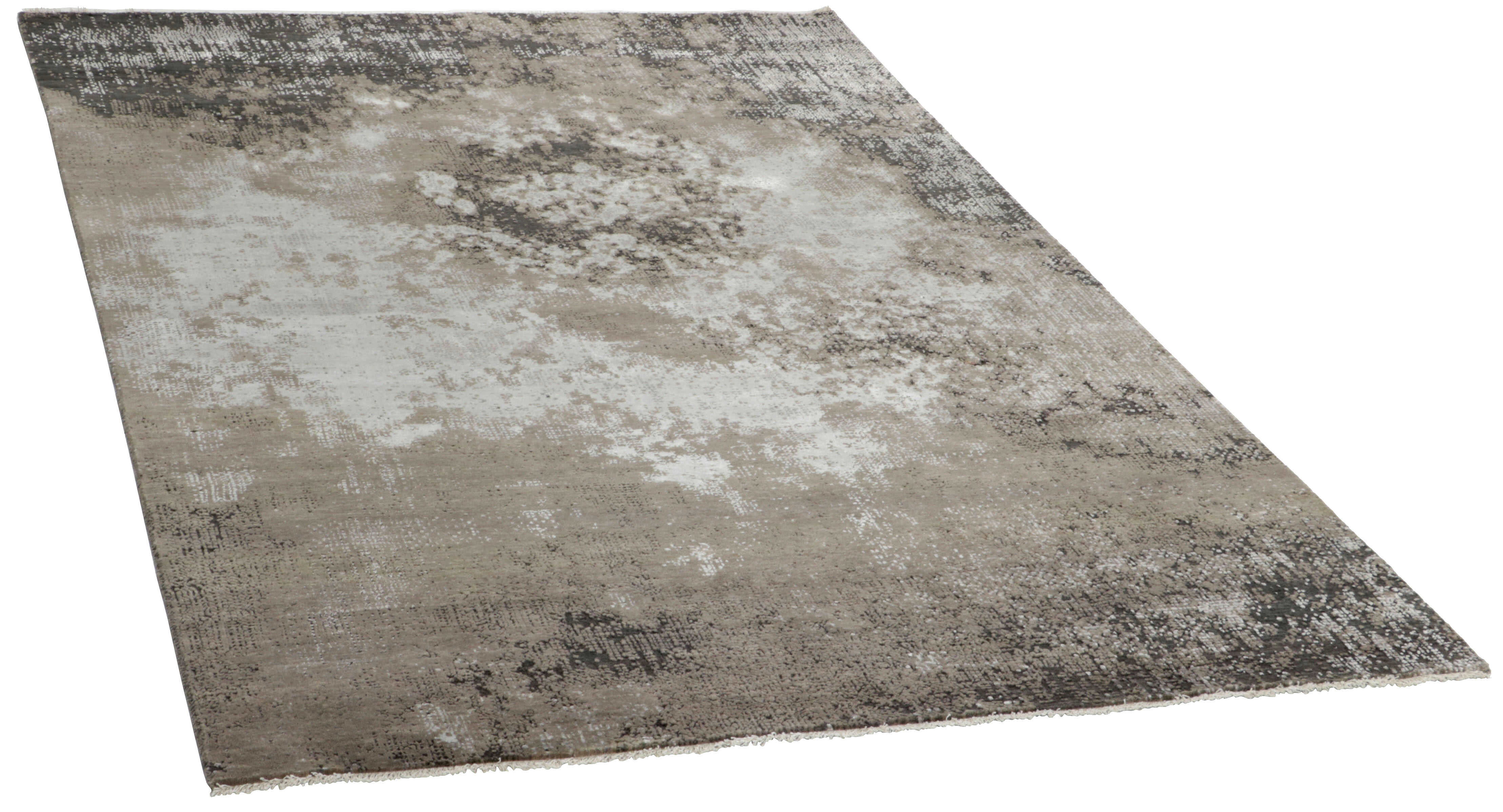 Large area rug with abstract design in grey and taupe