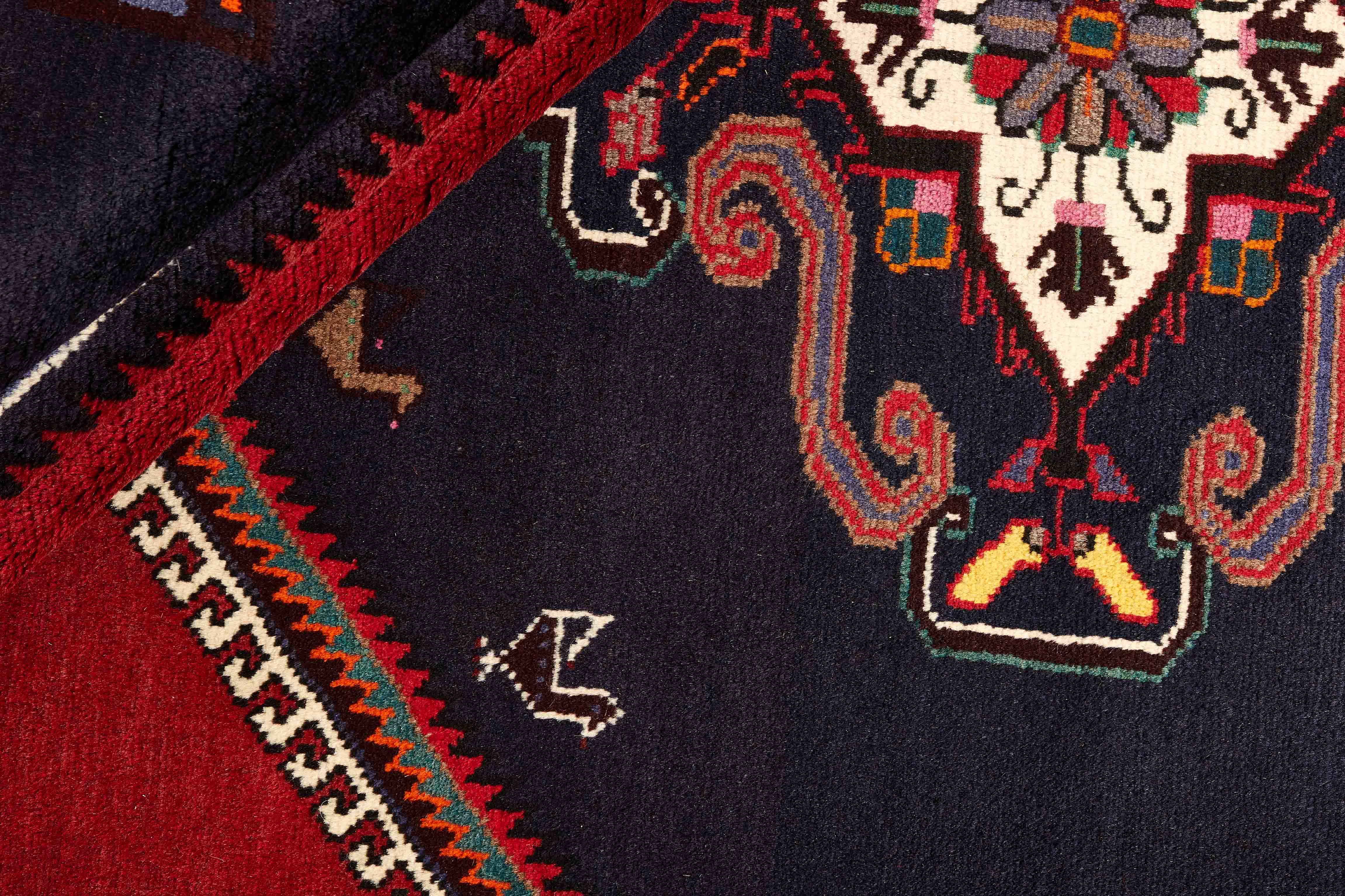 Authentic persian rug with a traditional geometric pattern in red