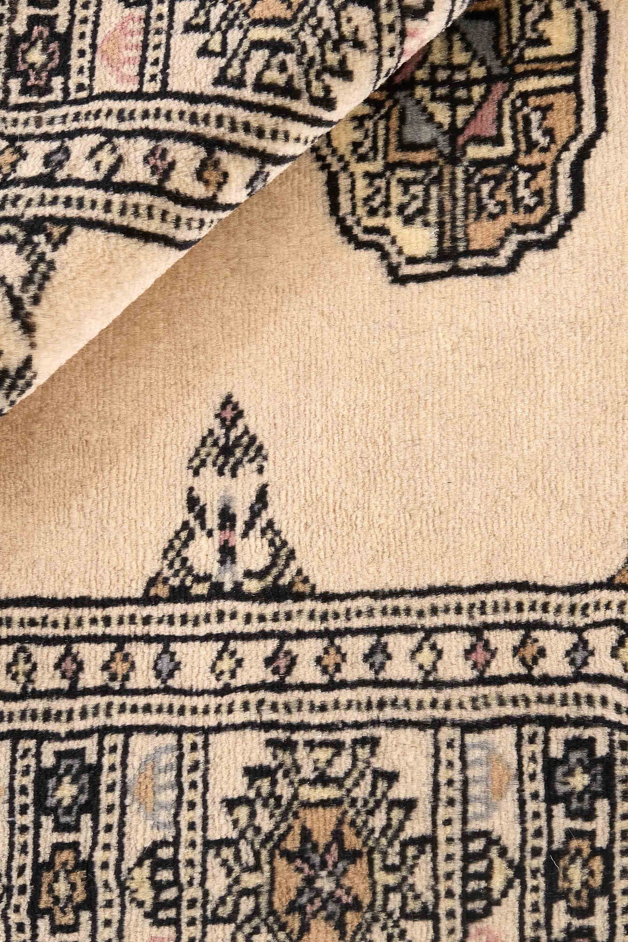Beige Oriental rug with traditional bordered pattern