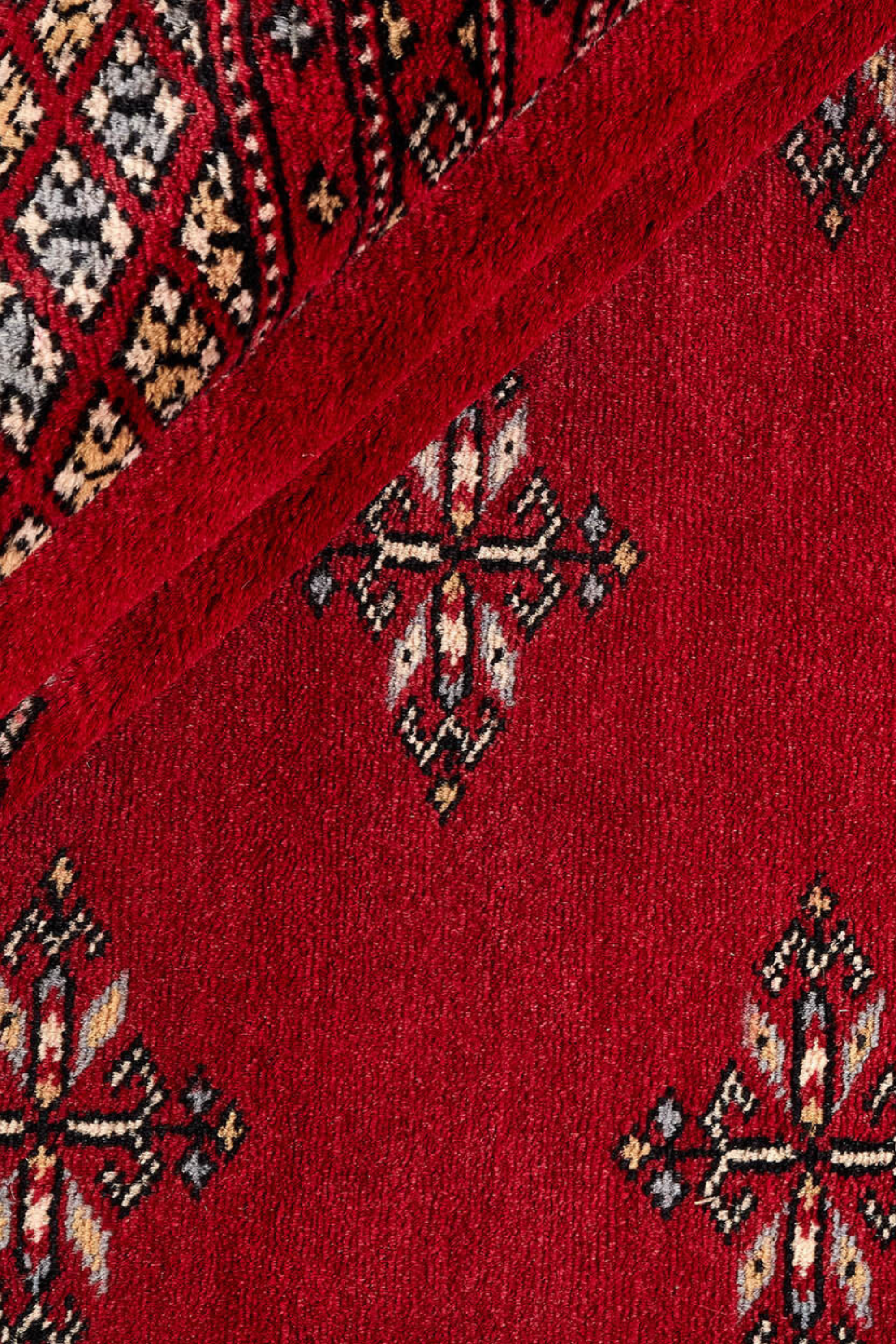 Red Oriental rug with traditional bordered pattern