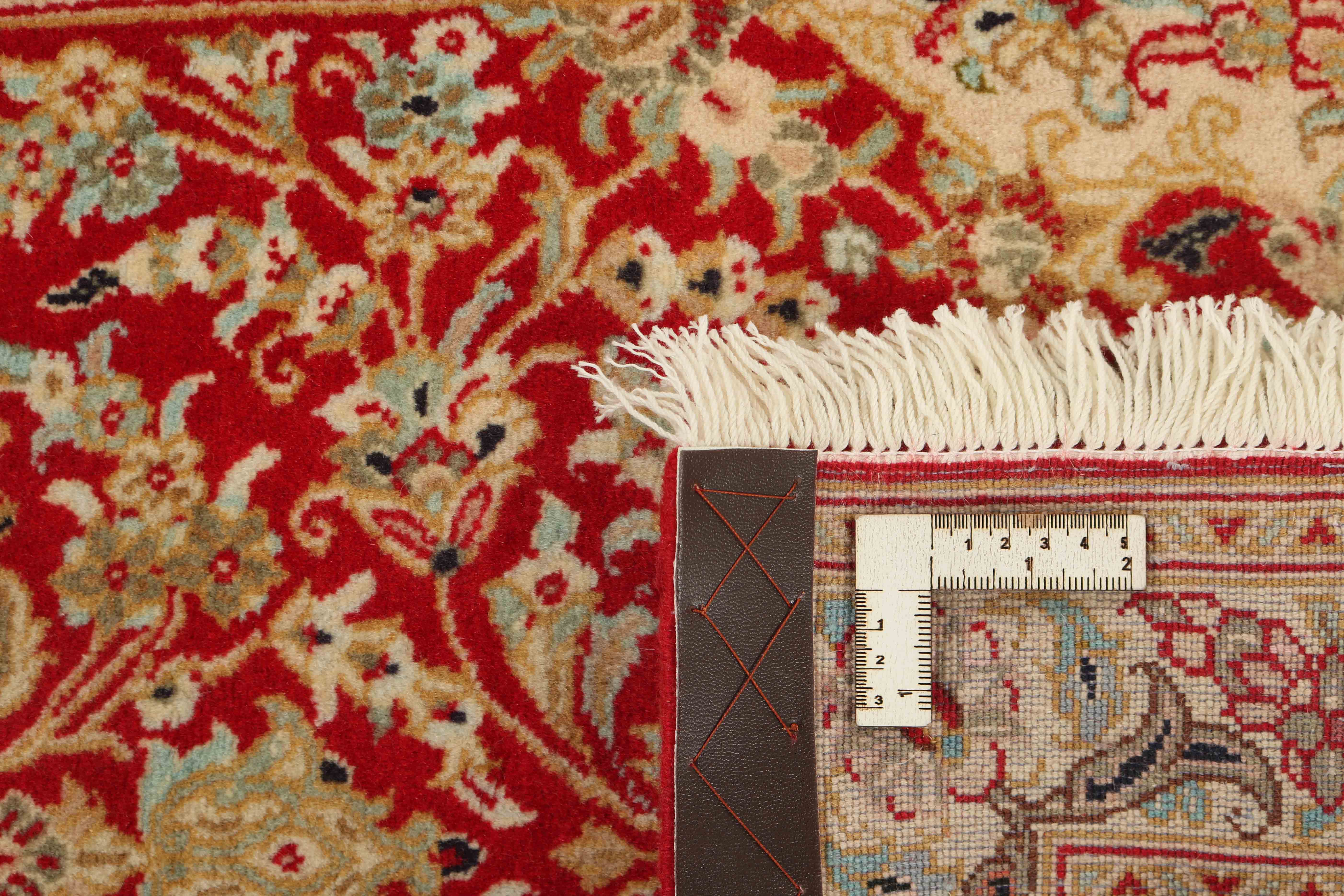 Authentic persian runner with a traditional floral design in red and beige