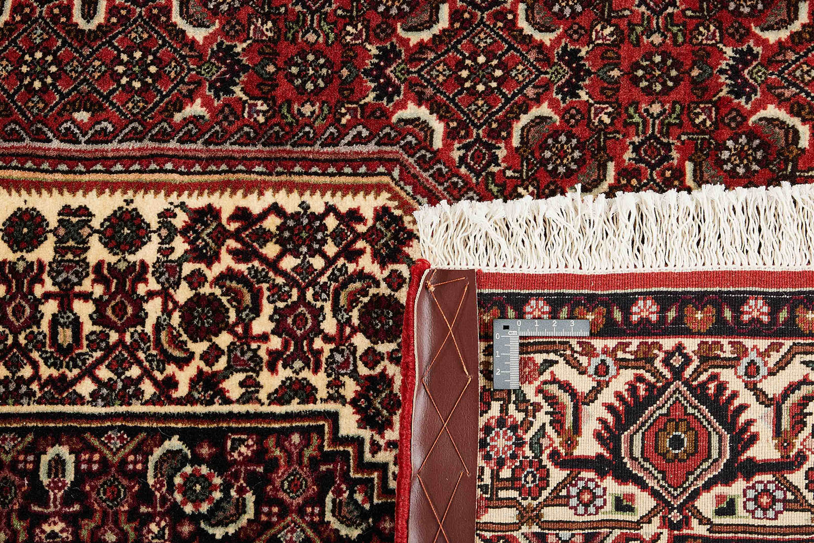Red and cream persian rug with traditional floral design