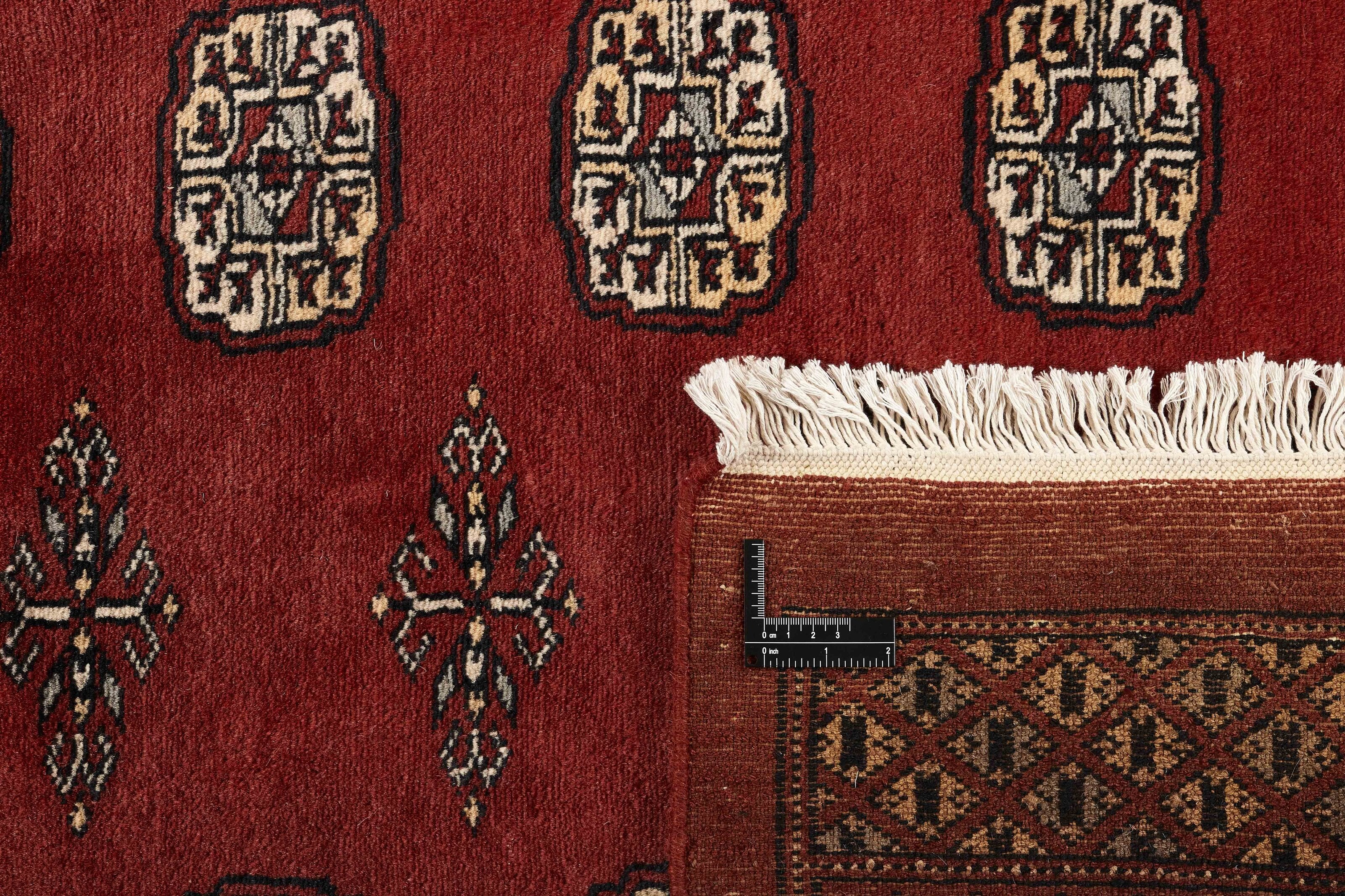 Red Oriental rug with traditional bordered pattern