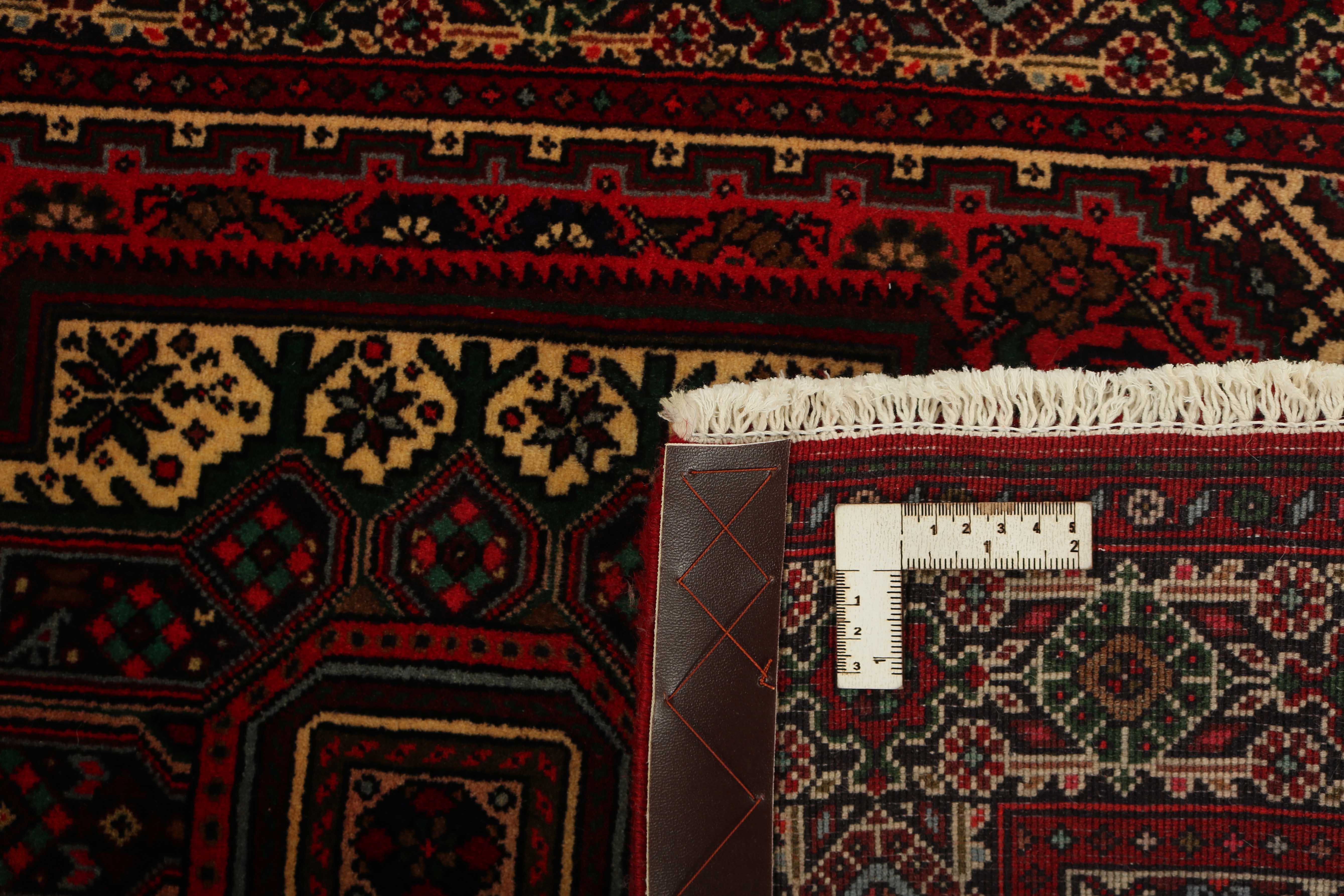Red and beige persian rug with a floral design