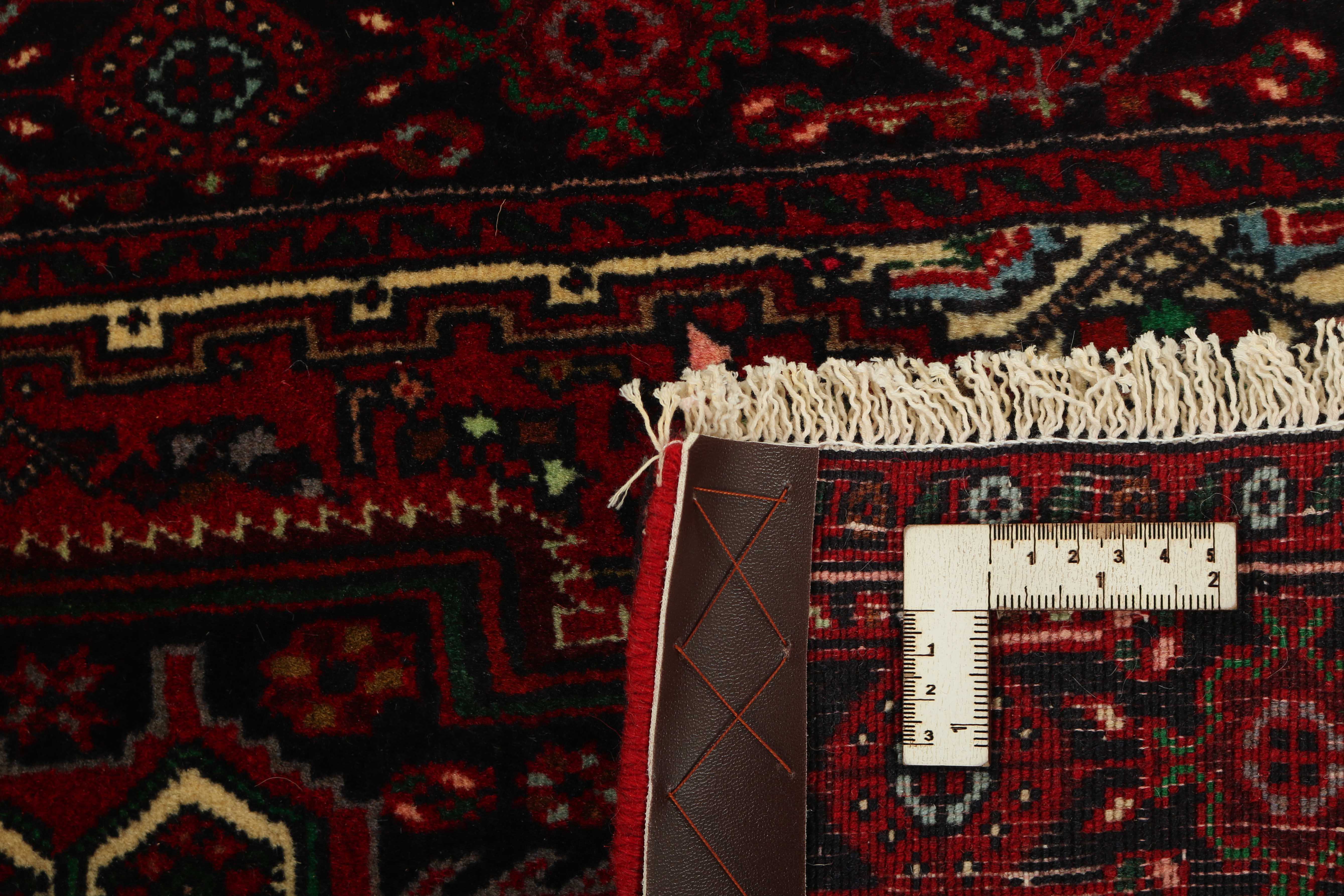 Red and beige persian rug with a floral design
