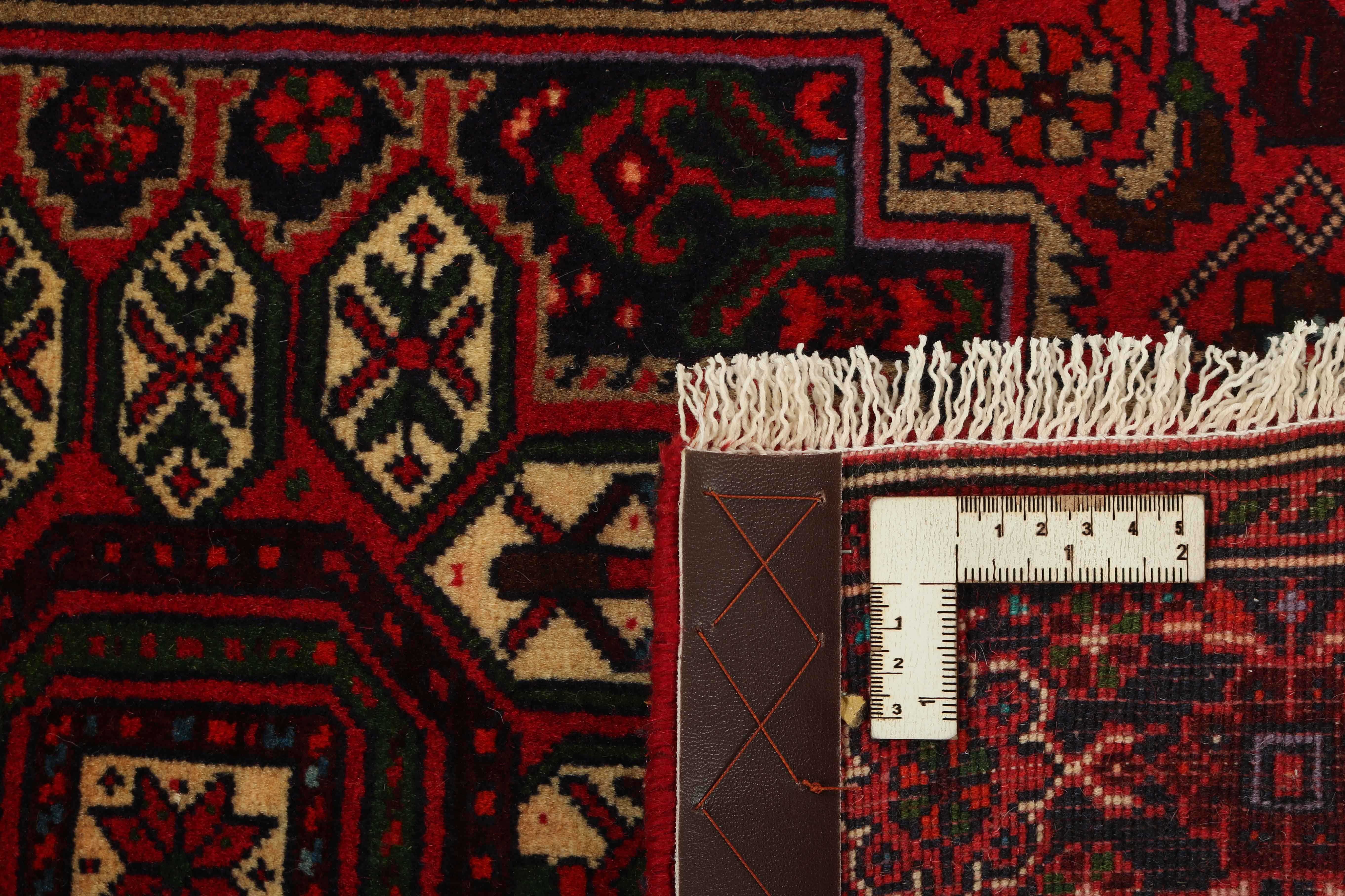 Red and beige persian rug with a floral design