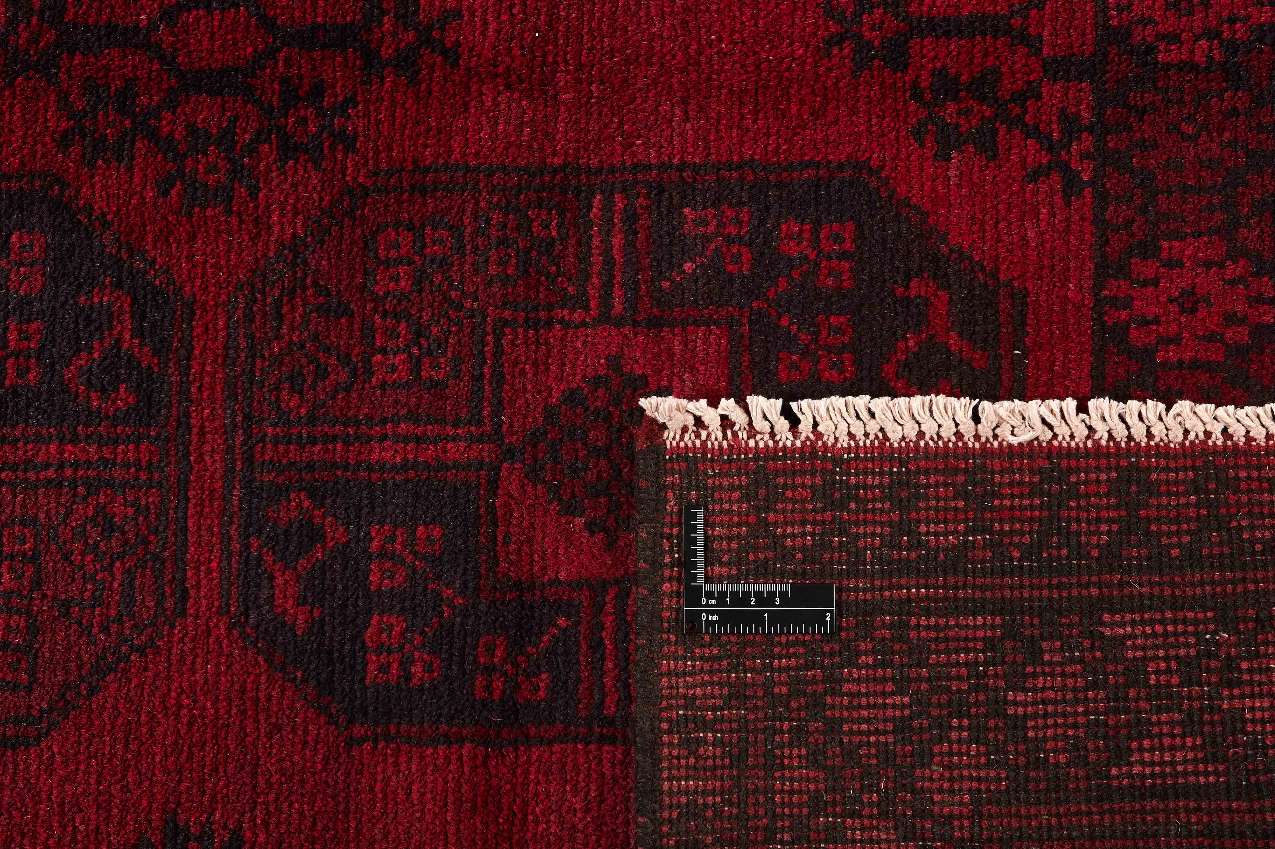 Red oriental rug with traditional elephant's foot pattern