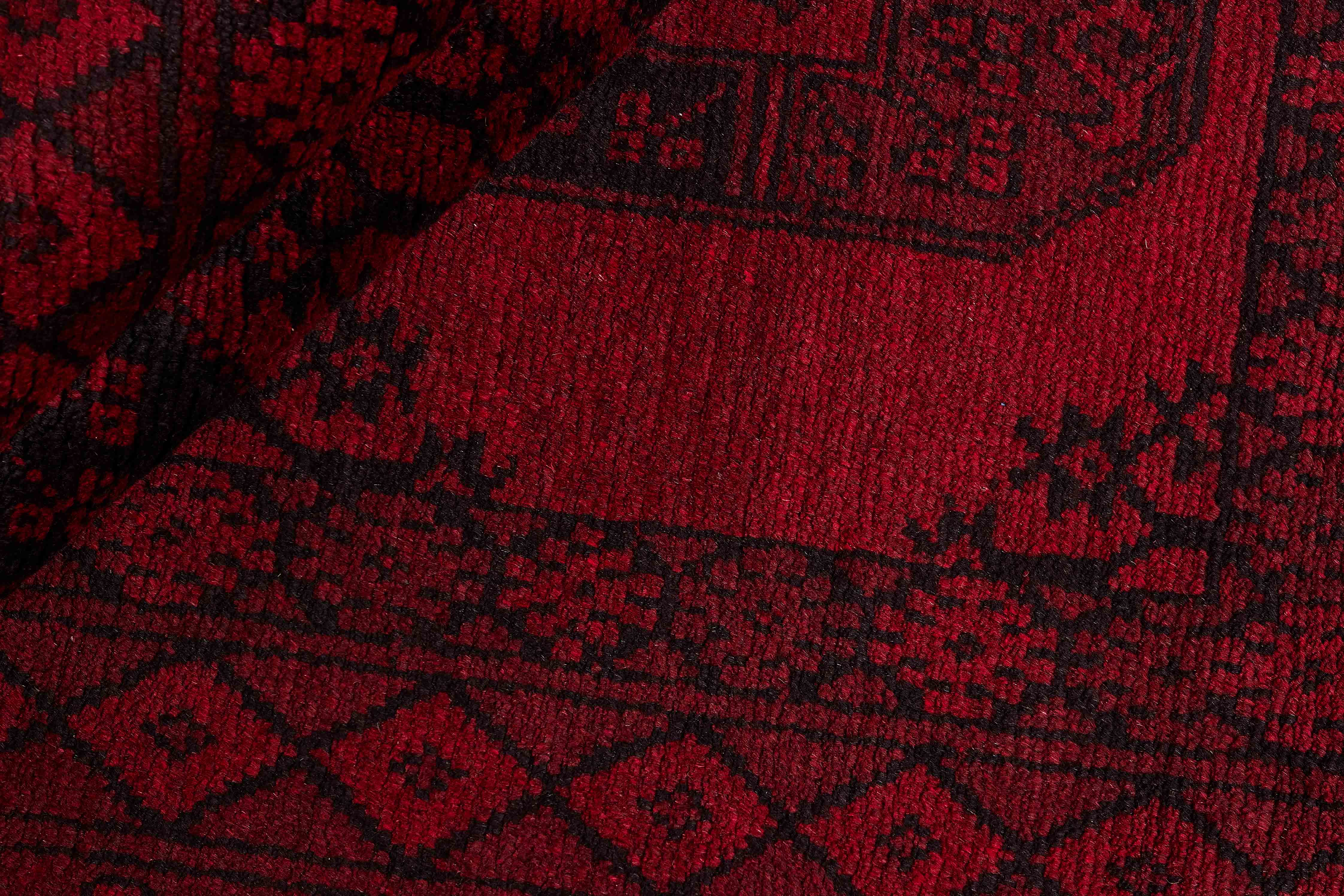 Red oriental rug with traditional elephant's foot pattern