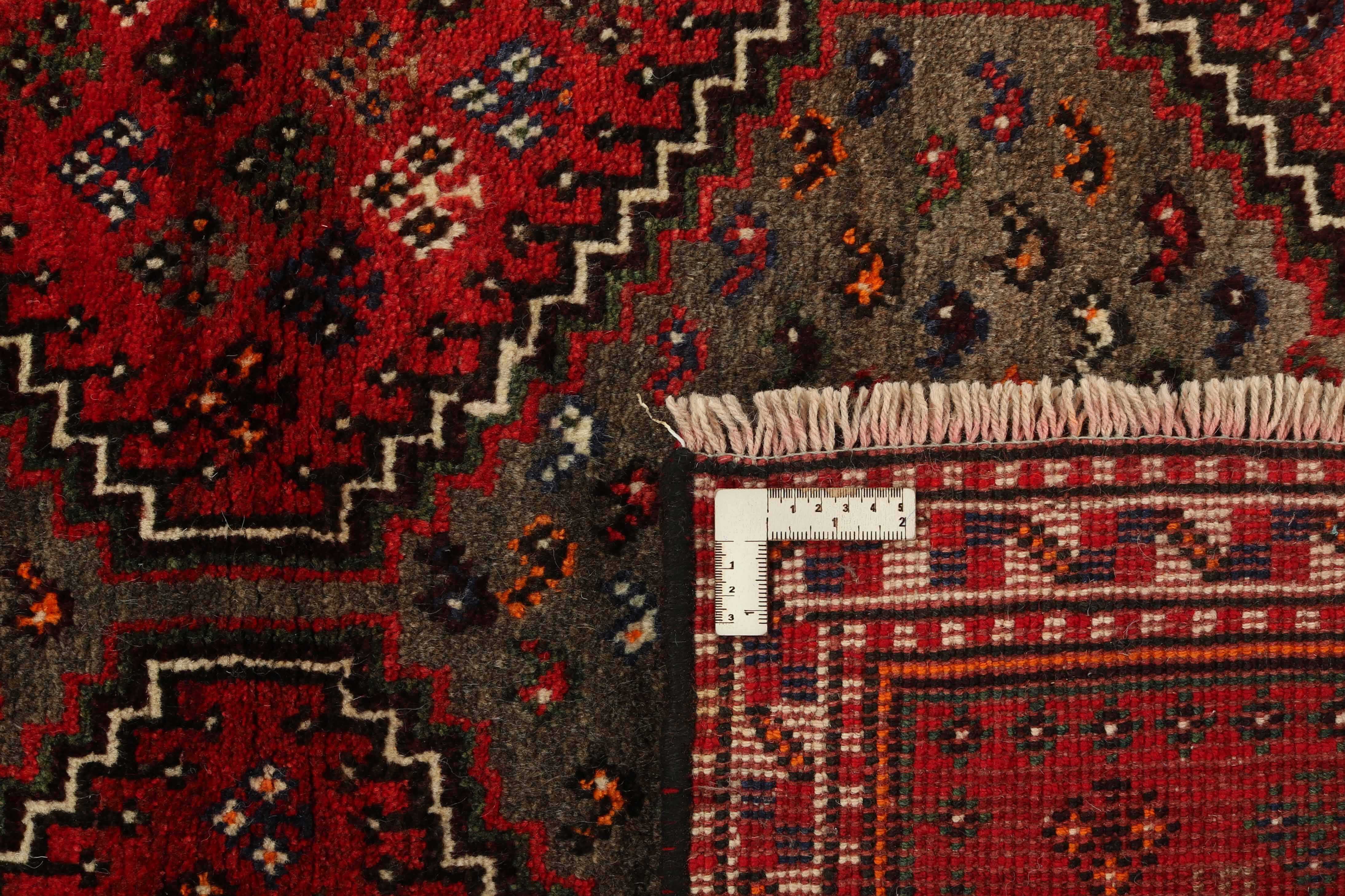 Authentic persian rug with a traditional tribal geometric pattern in red