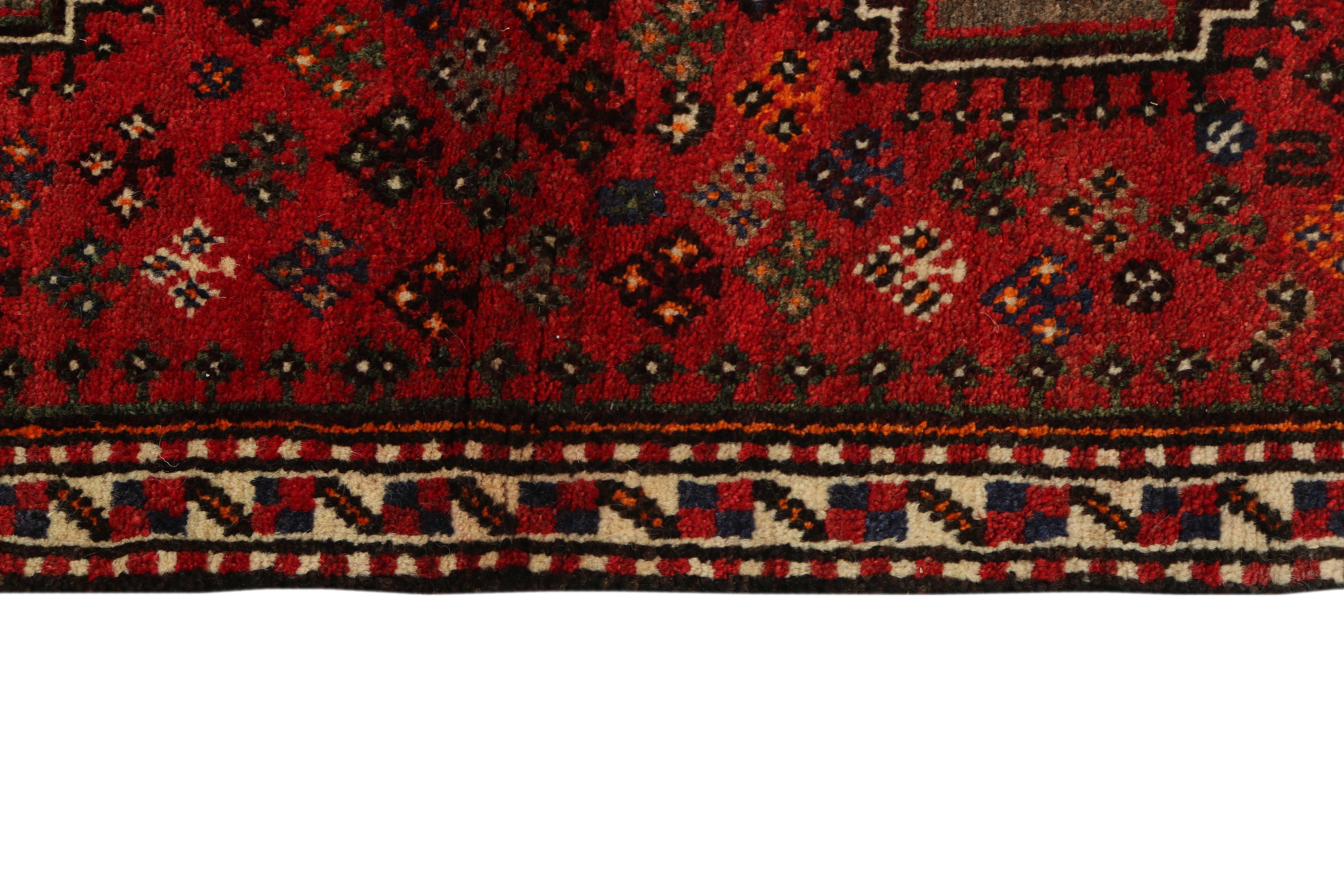 Authentic persian rug with a traditional tribal geometric pattern in red