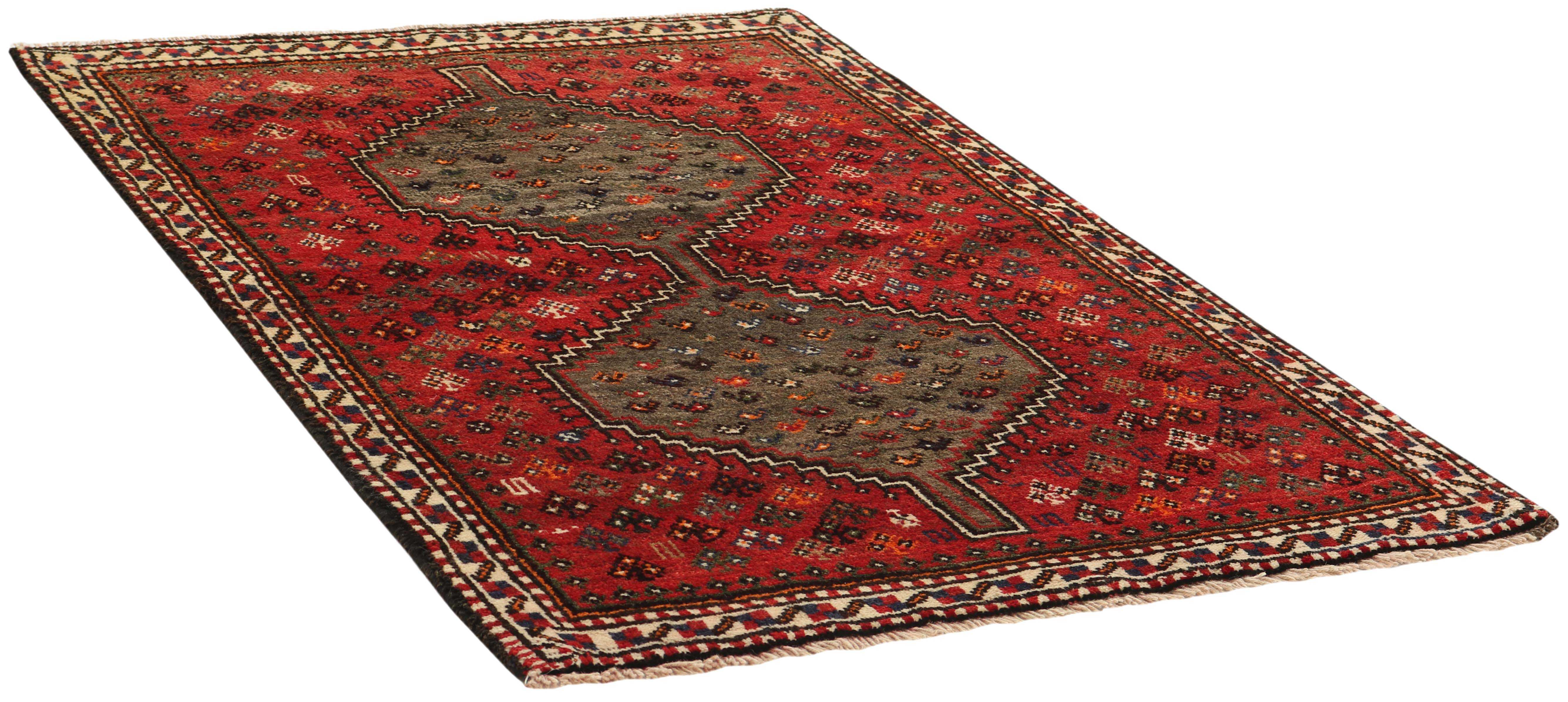 Authentic persian rug with a traditional tribal geometric pattern in red