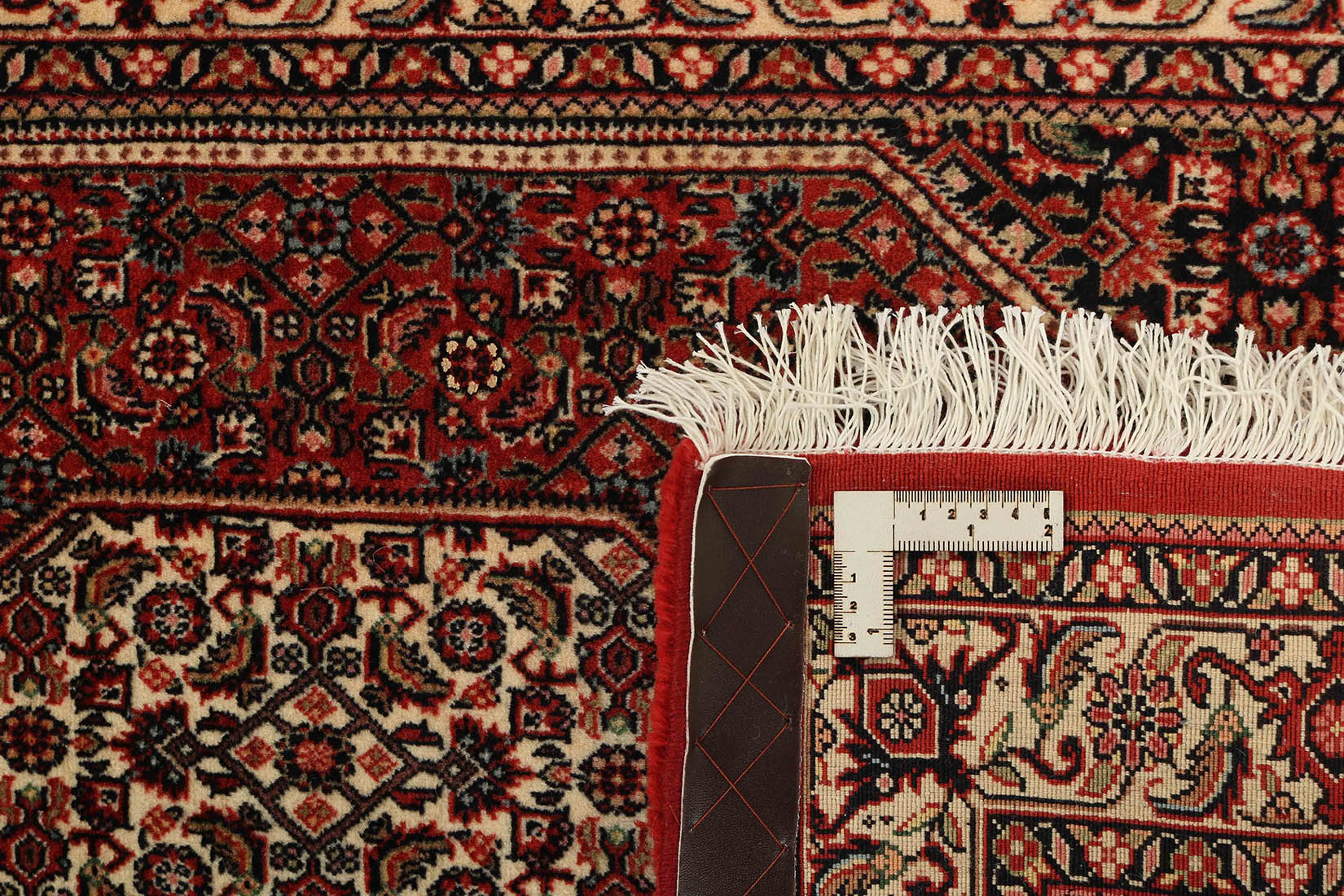 Red and cream persian wool and silk runner with traditional floral design
