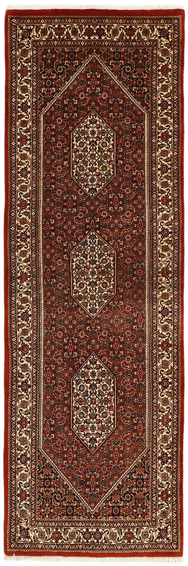 Red and cream persian wool and silk runner with traditional floral design