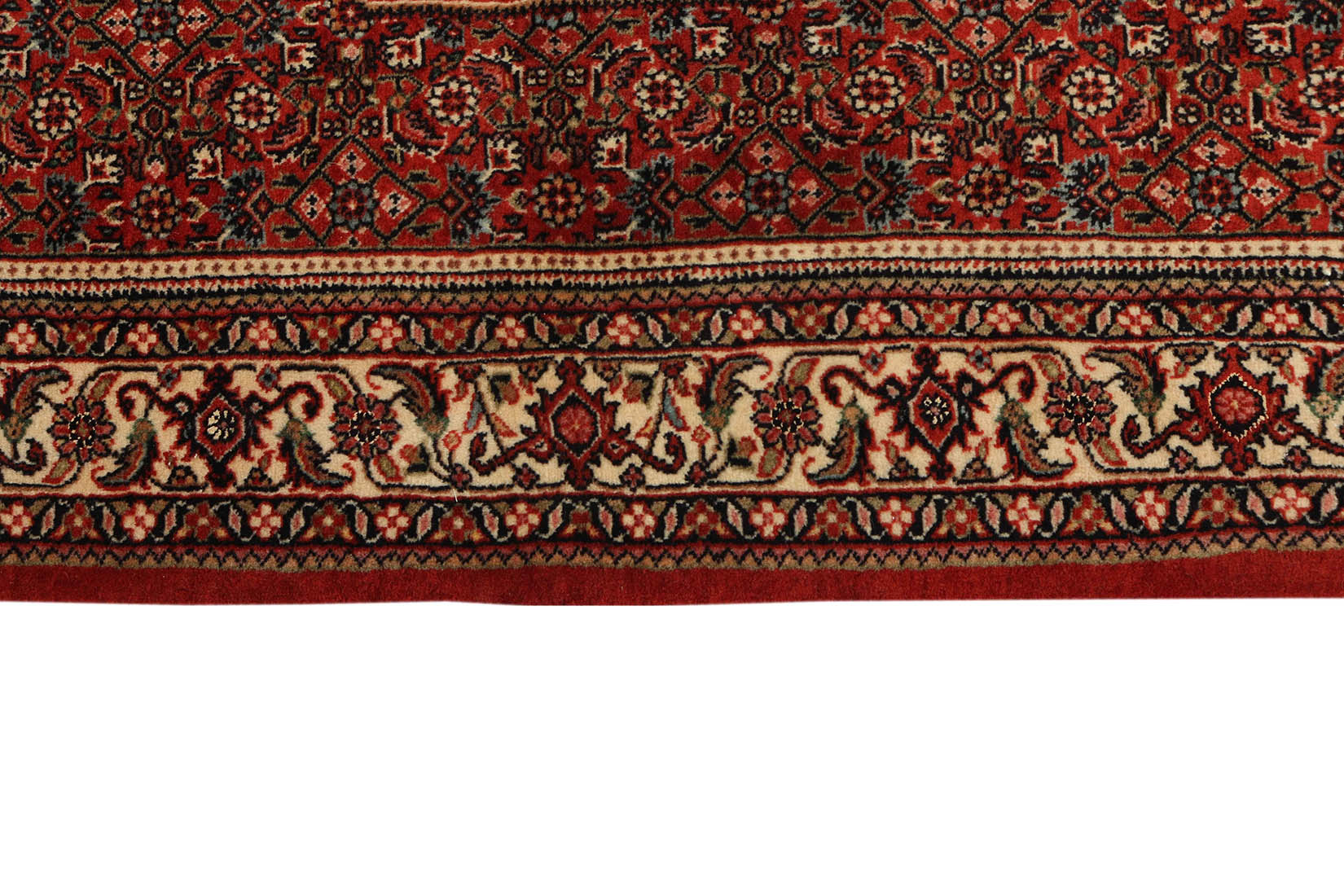 Red and cream persian wool and silk runner with traditional floral design