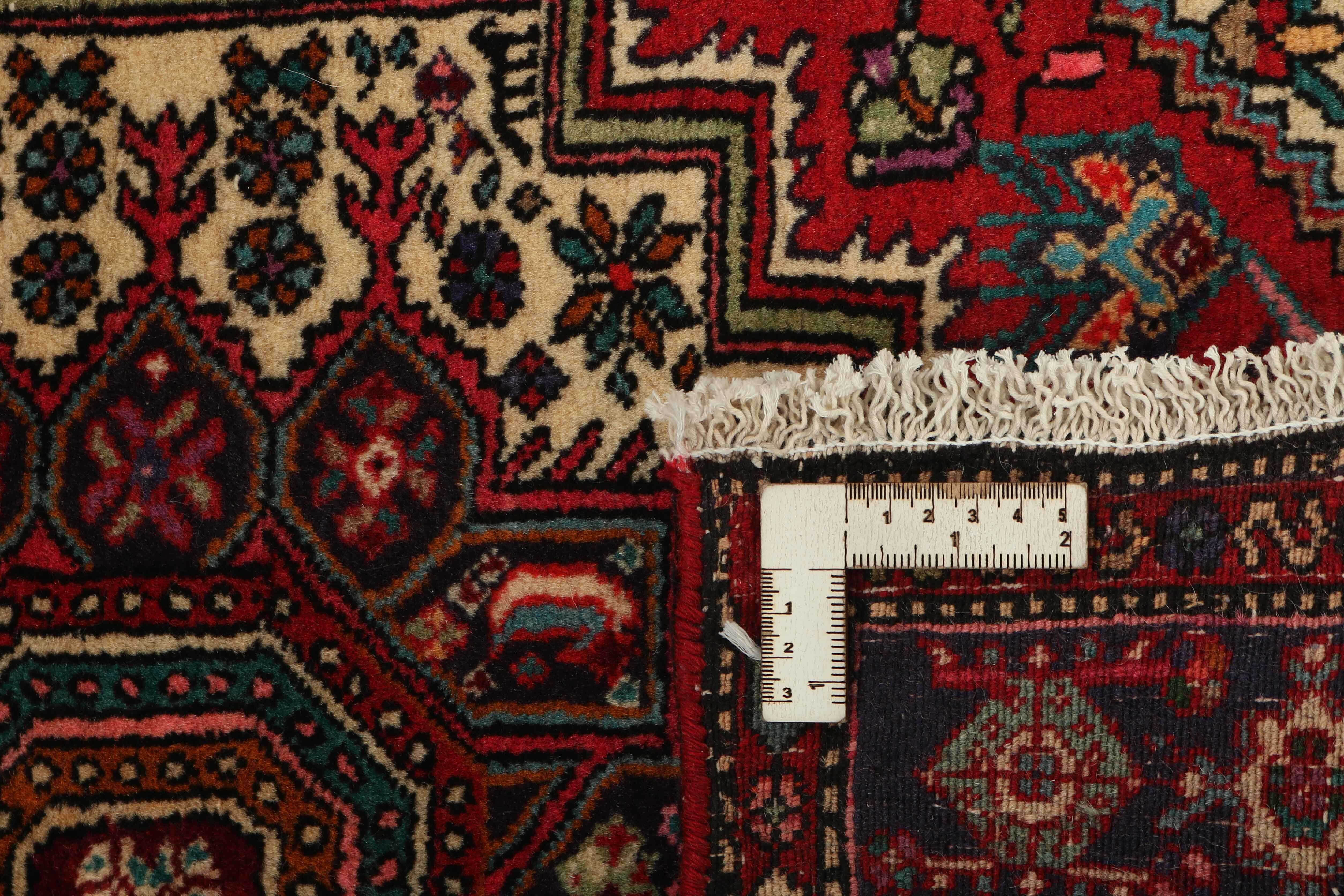 Red persian rug with a floral design