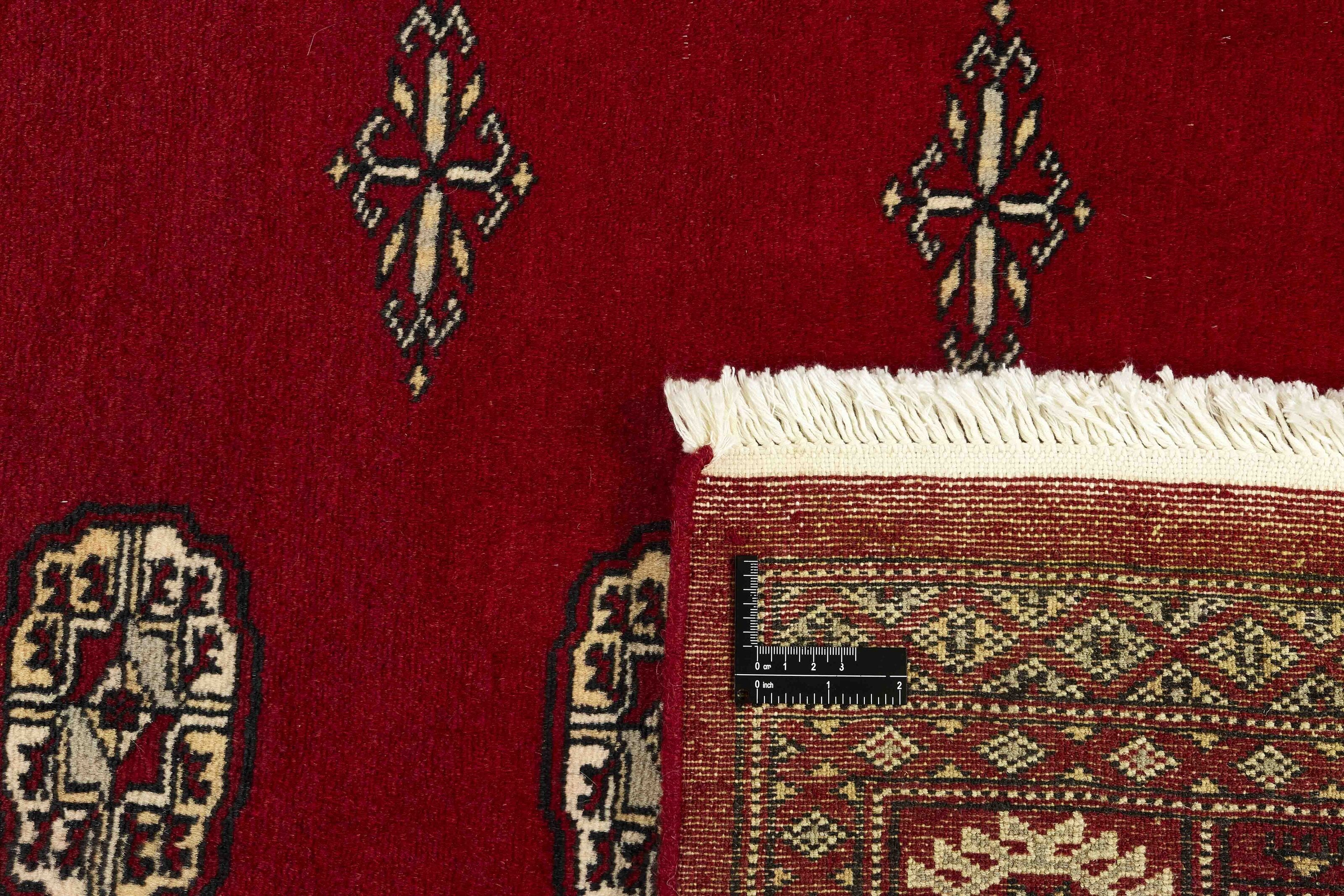 Red Oriental rug with traditional bordered pattern