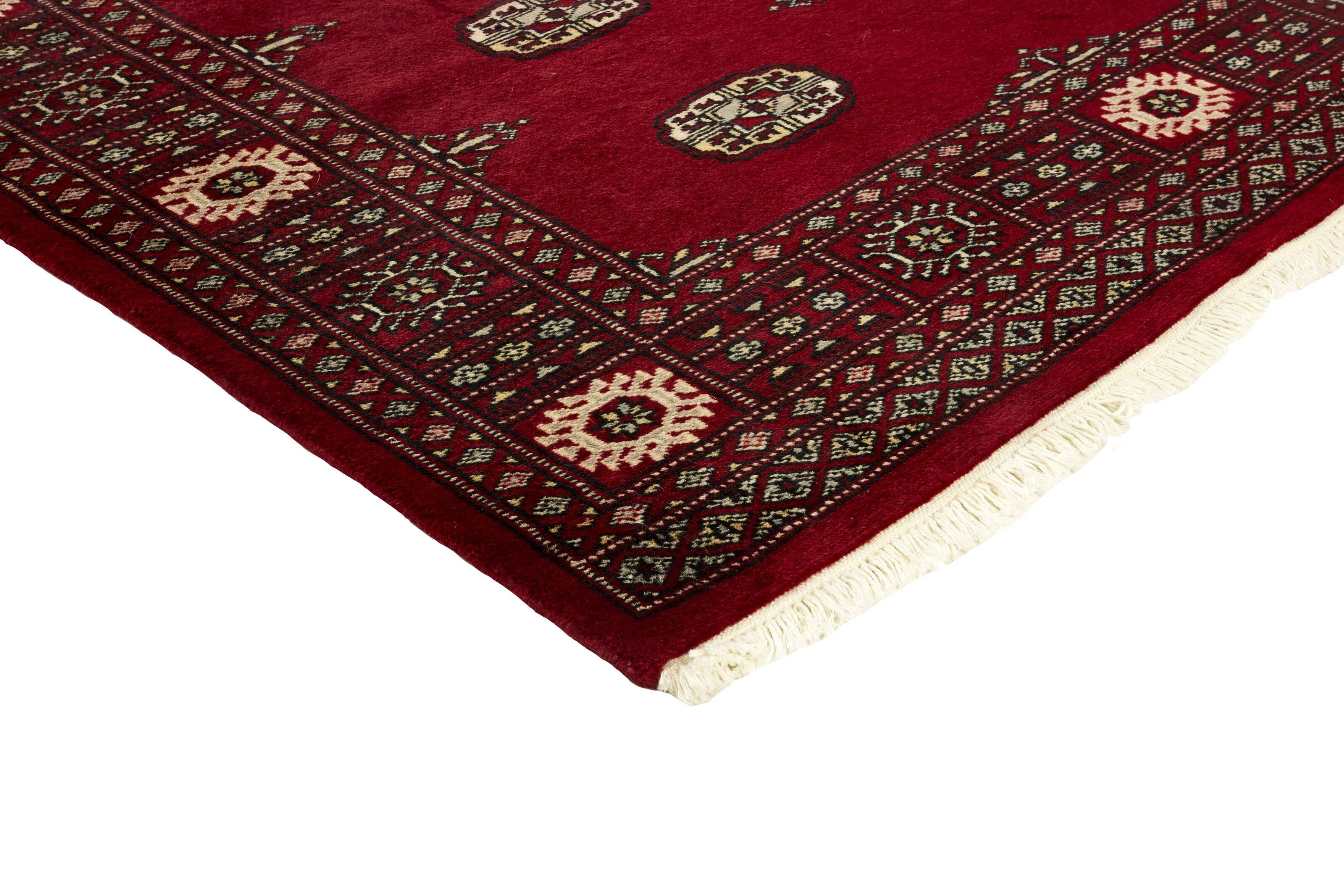 Red Oriental rug with traditional bordered pattern