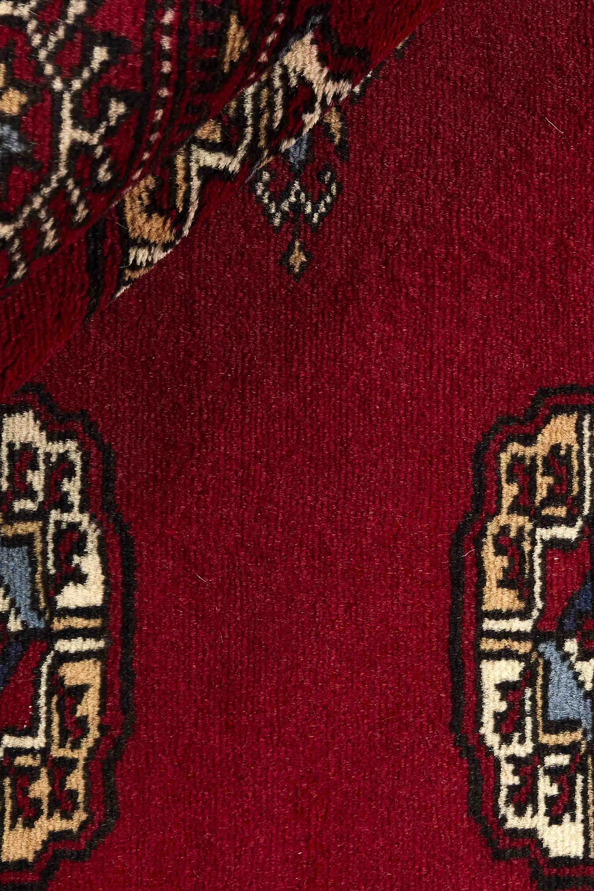 Red Oriental rug with traditional bordered pattern