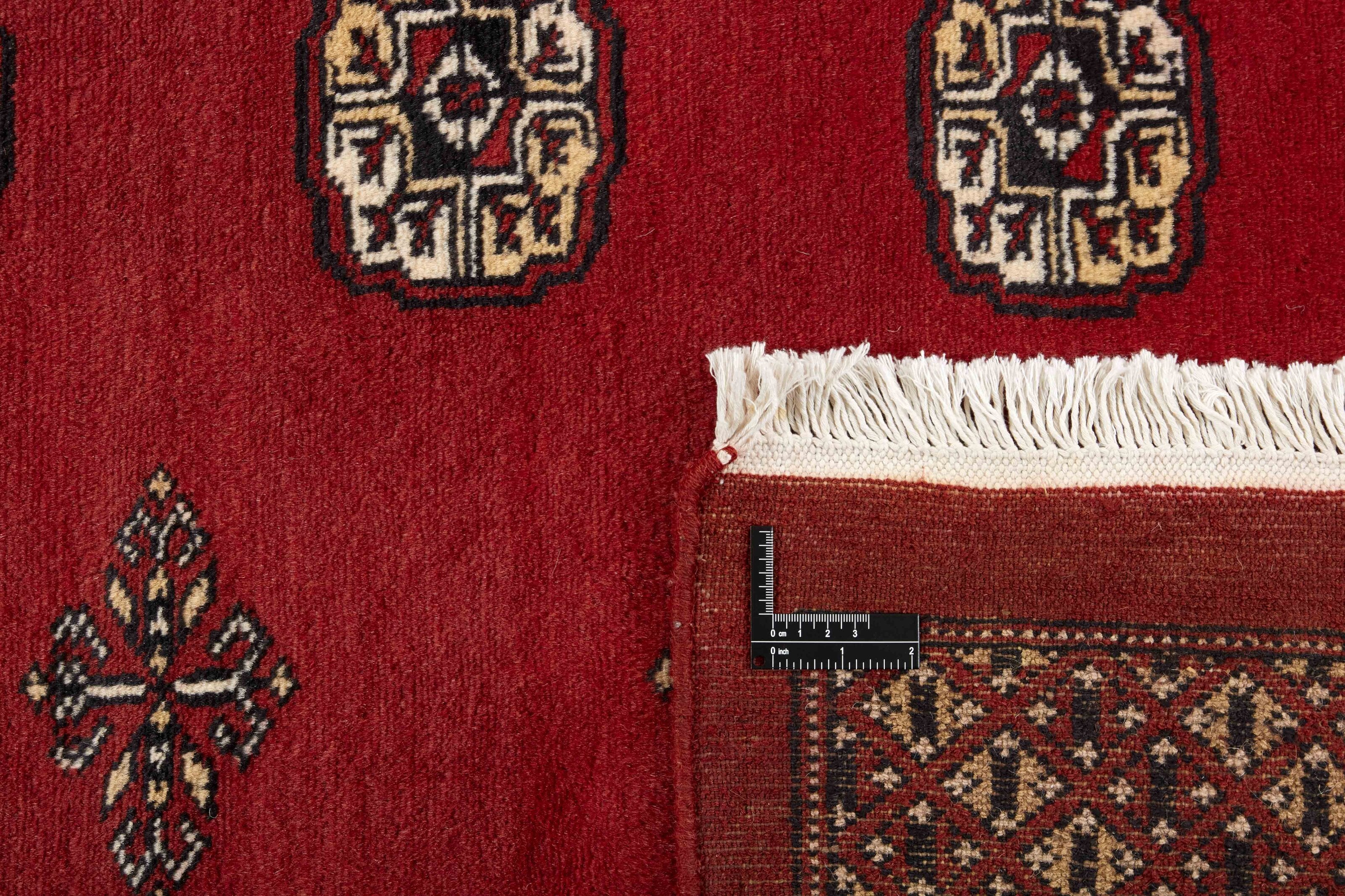 Red Oriental rug with traditional bordered pattern