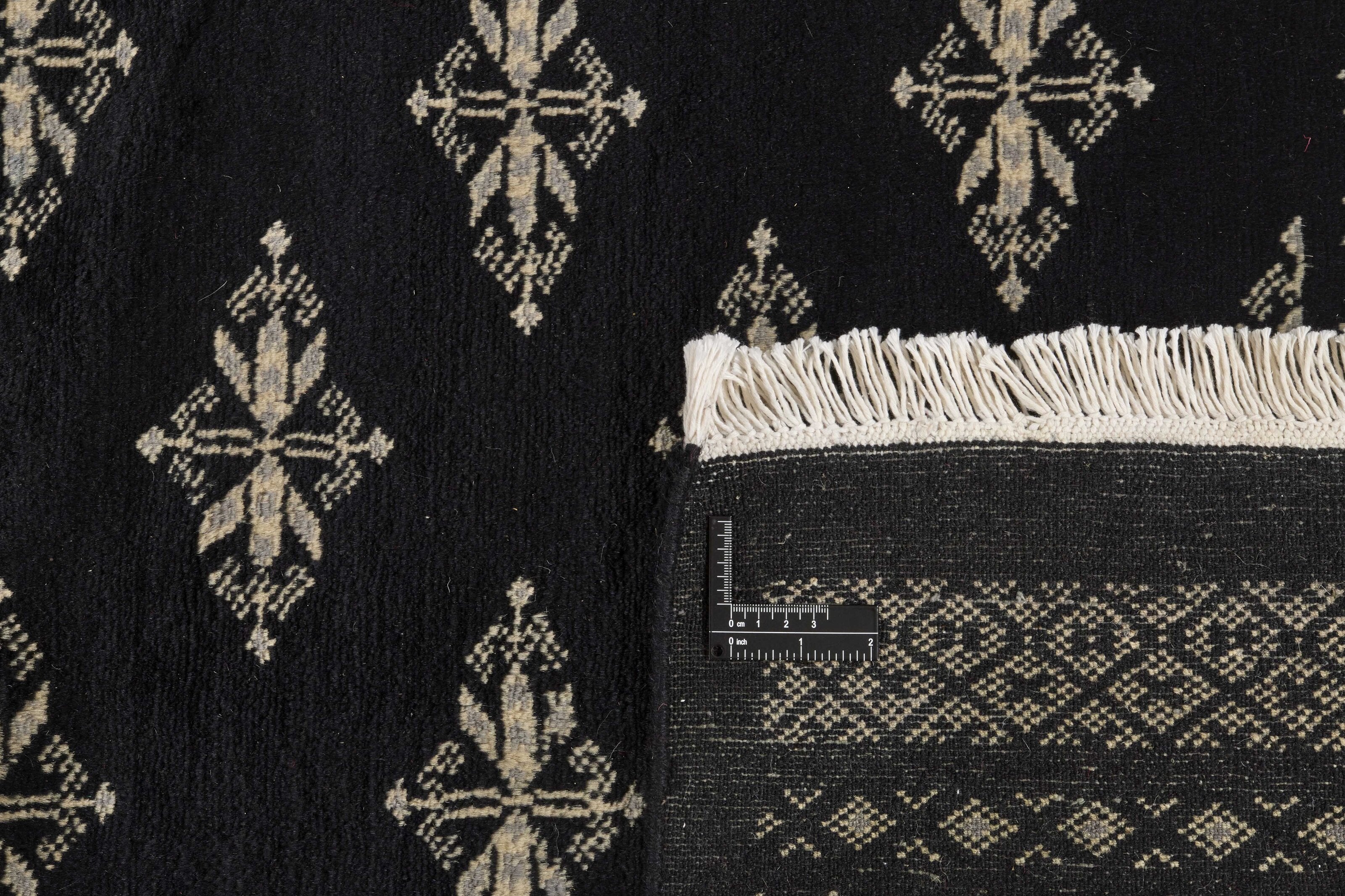 Black Oriental rug with traditional bordered pattern