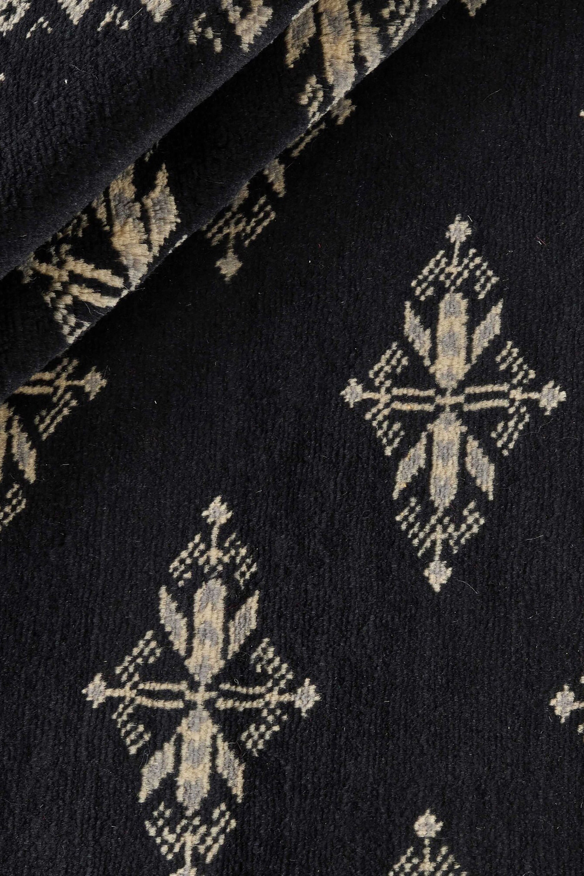 Black Oriental rug with traditional bordered pattern