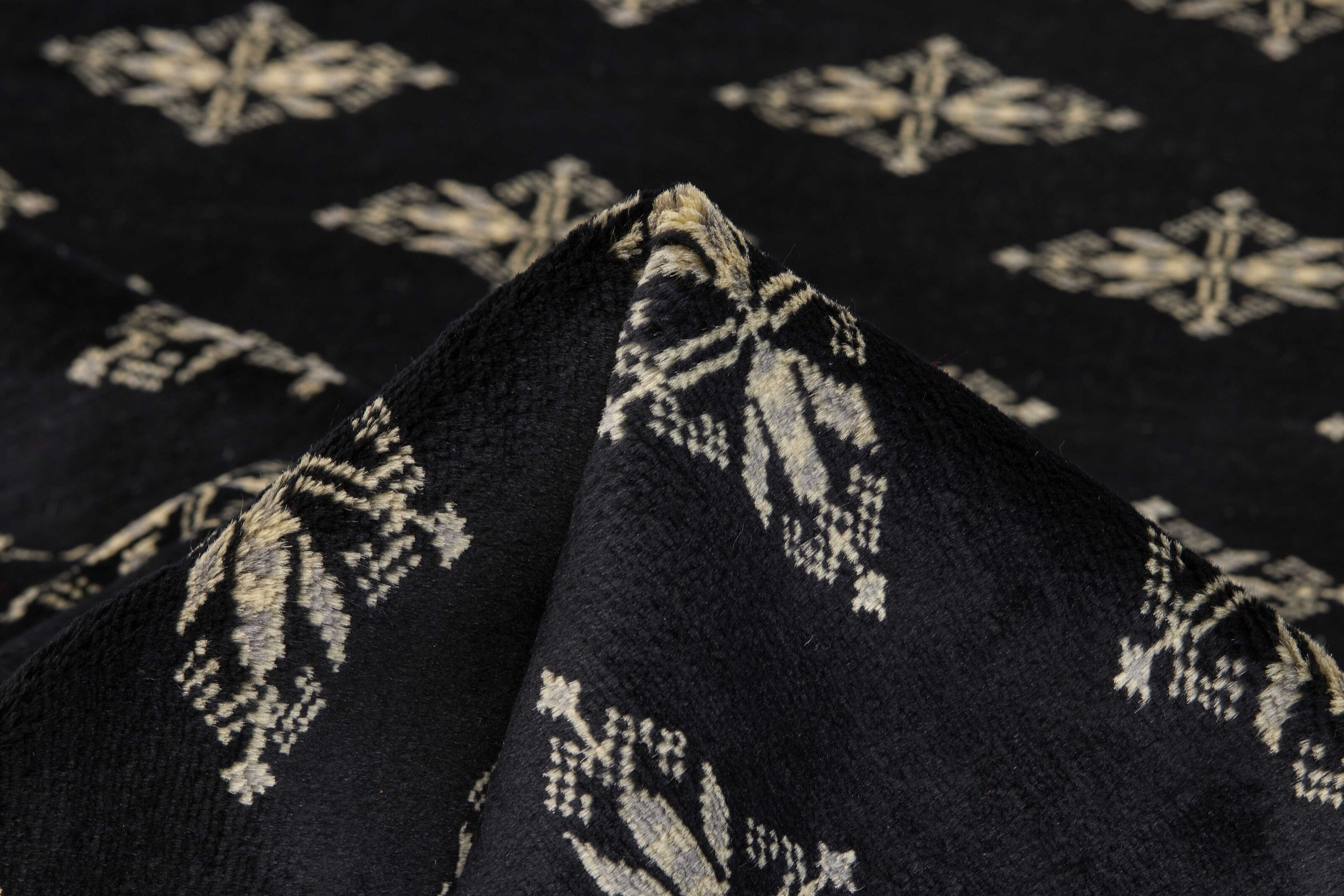 Black Oriental rug with traditional bordered pattern