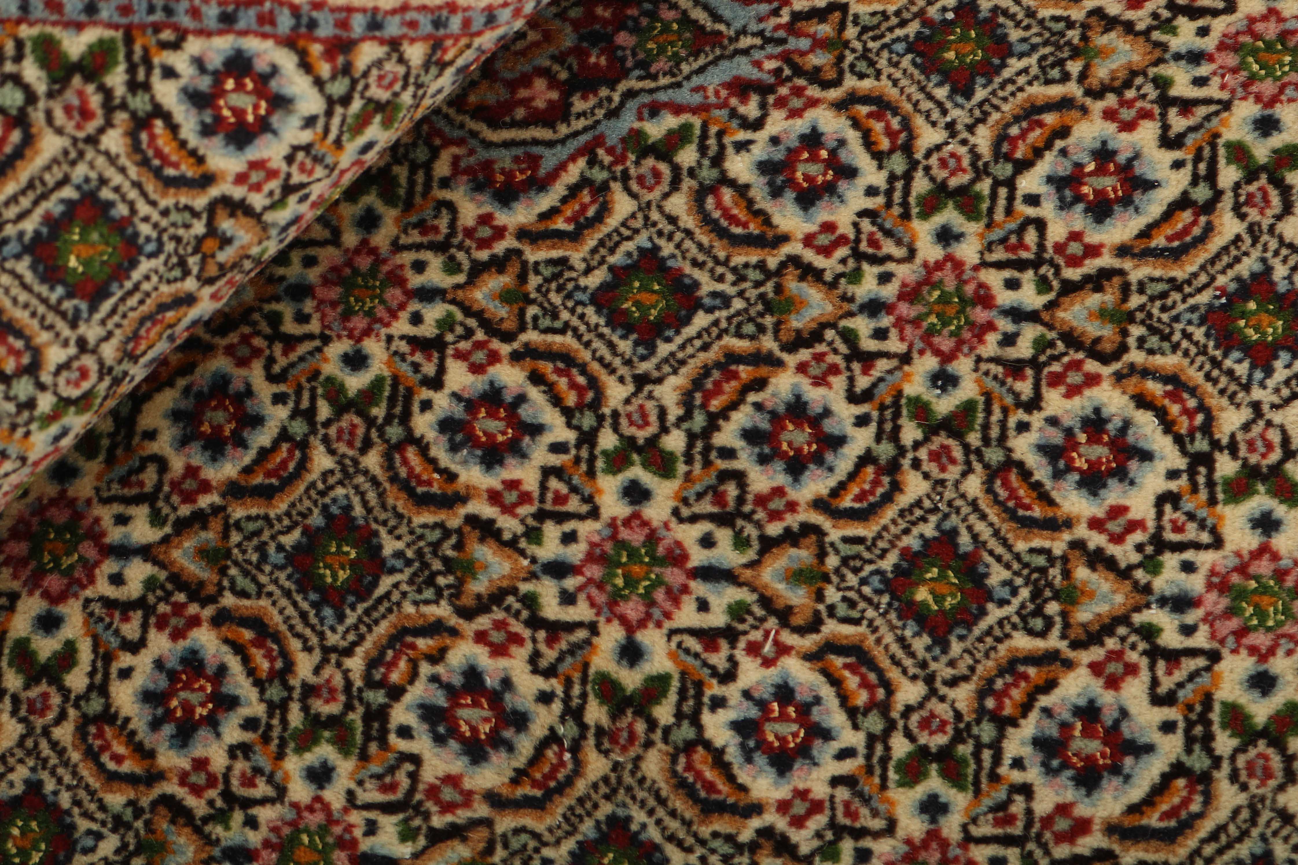 authentic persian rug with traditional floral pattern in beige