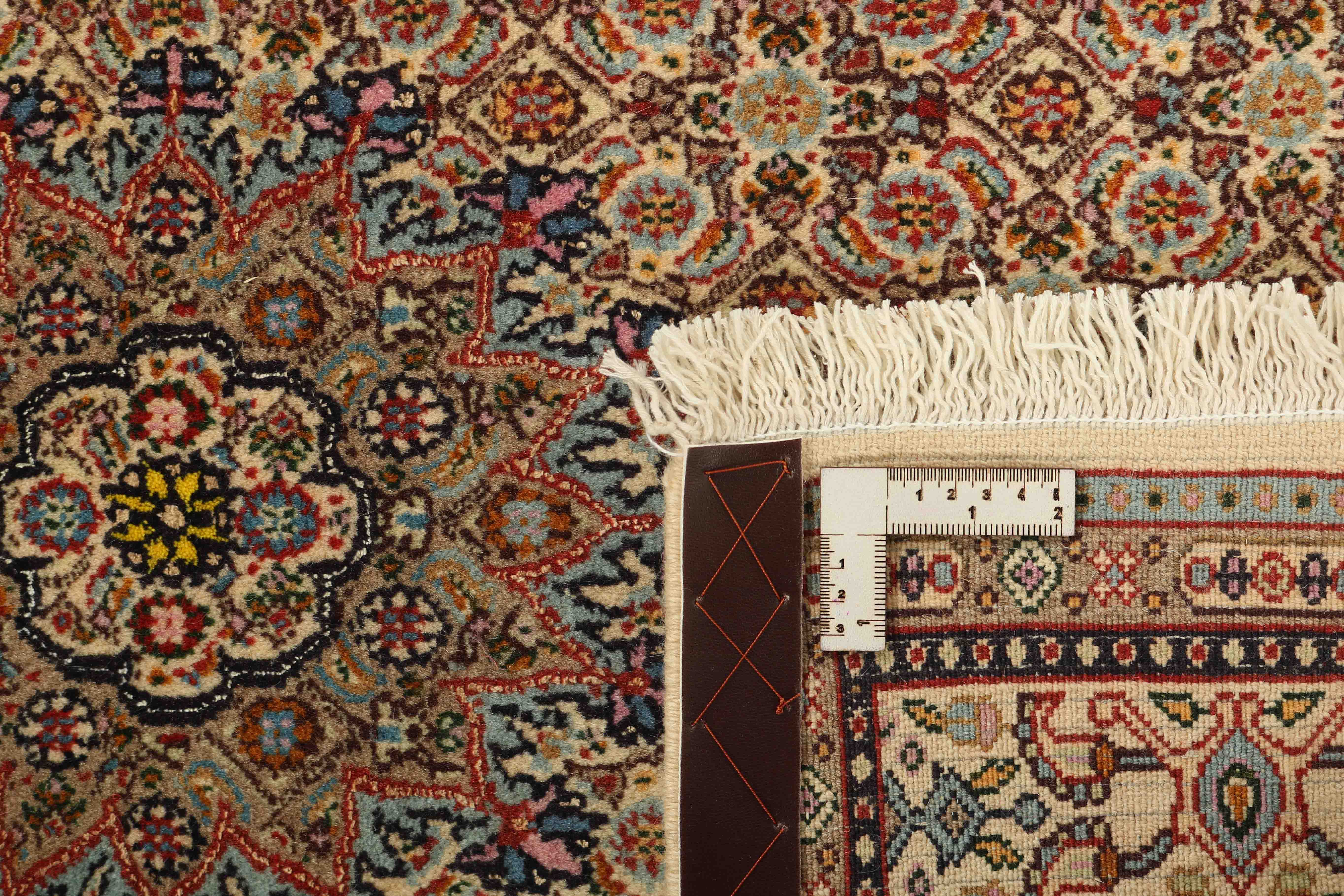 authentic persian rug with traditional floral pattern in beige