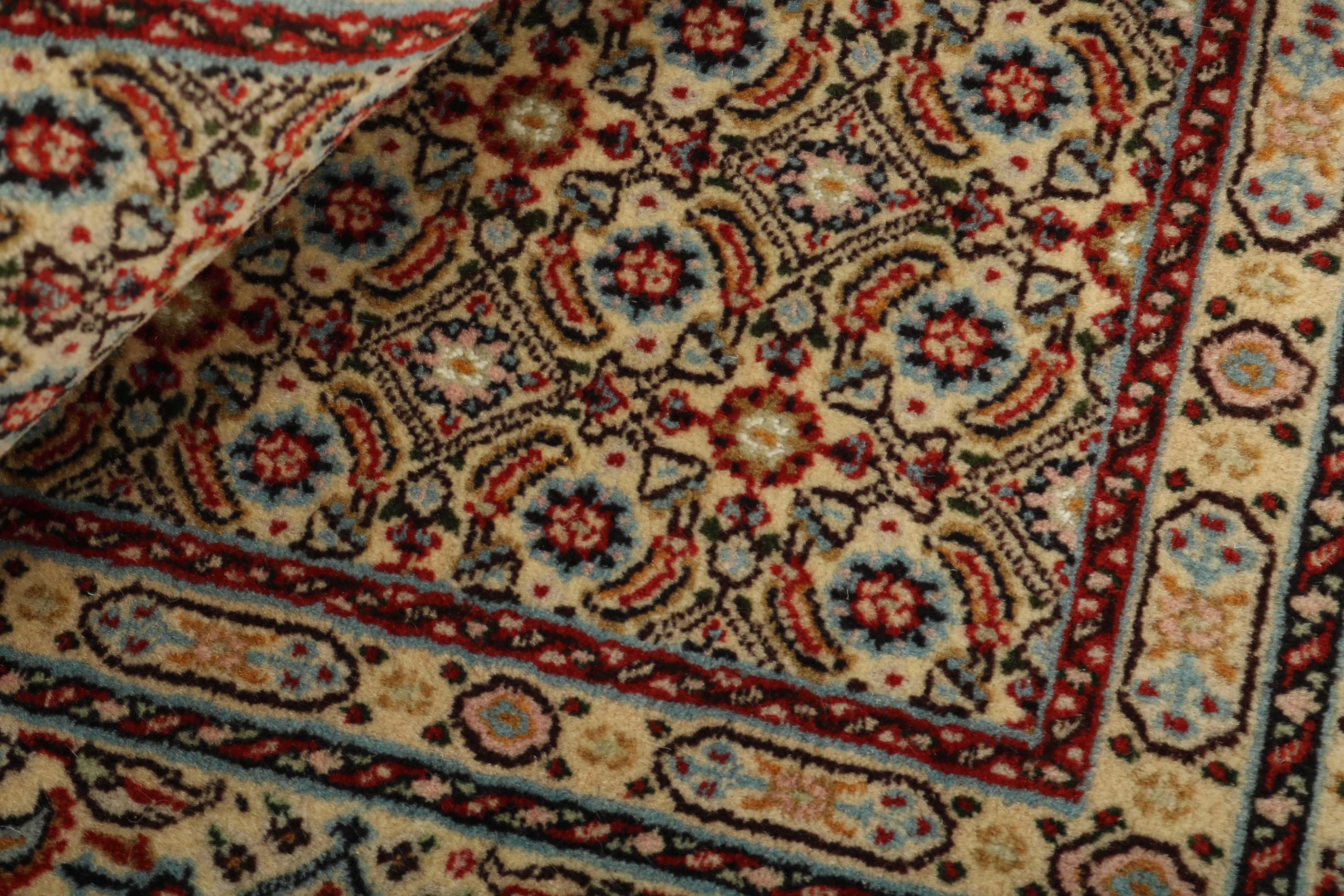 authentic persian rug with traditional floral pattern in beige