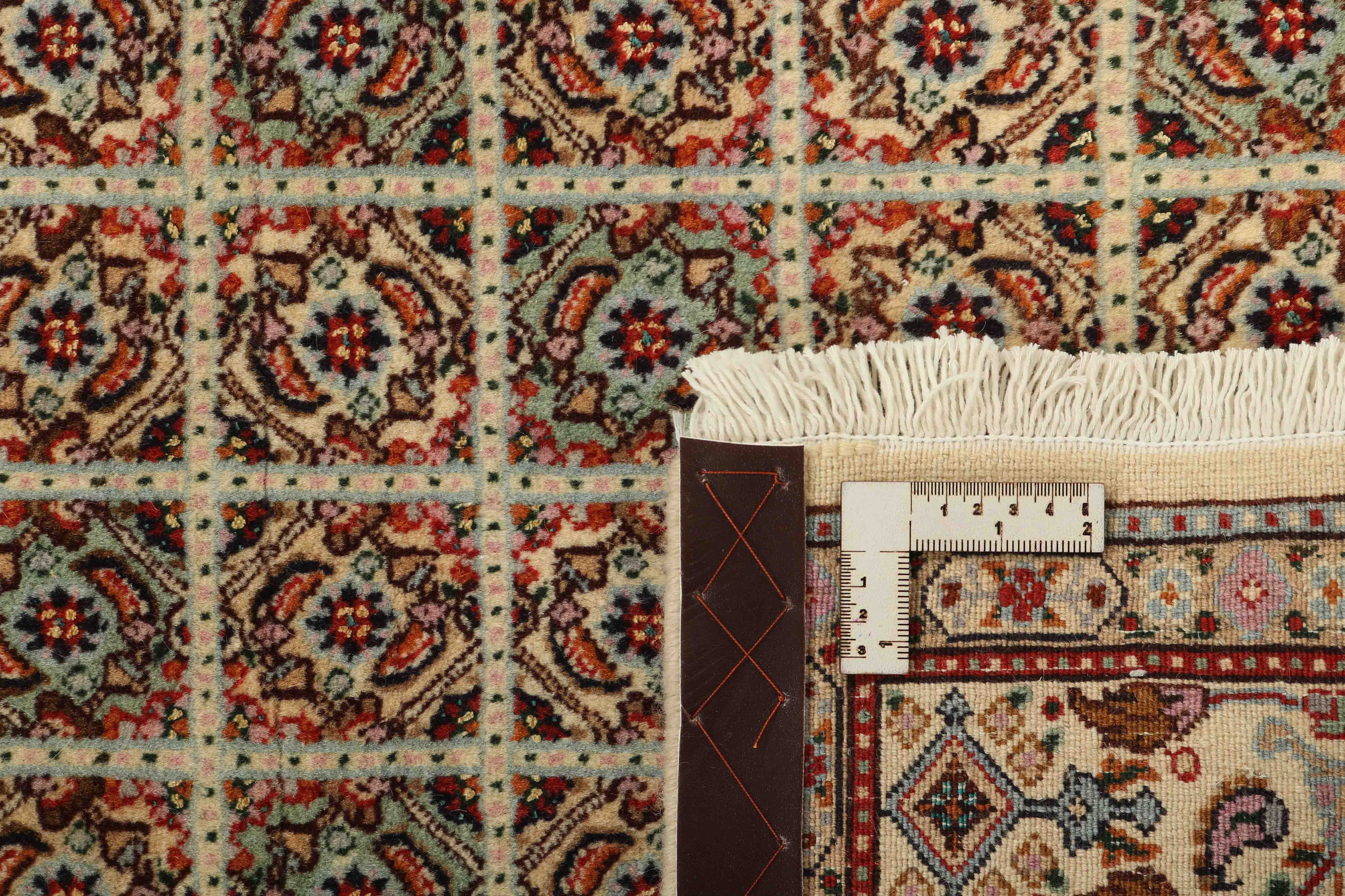 authentic persian rug with traditional floral pattern in beige
