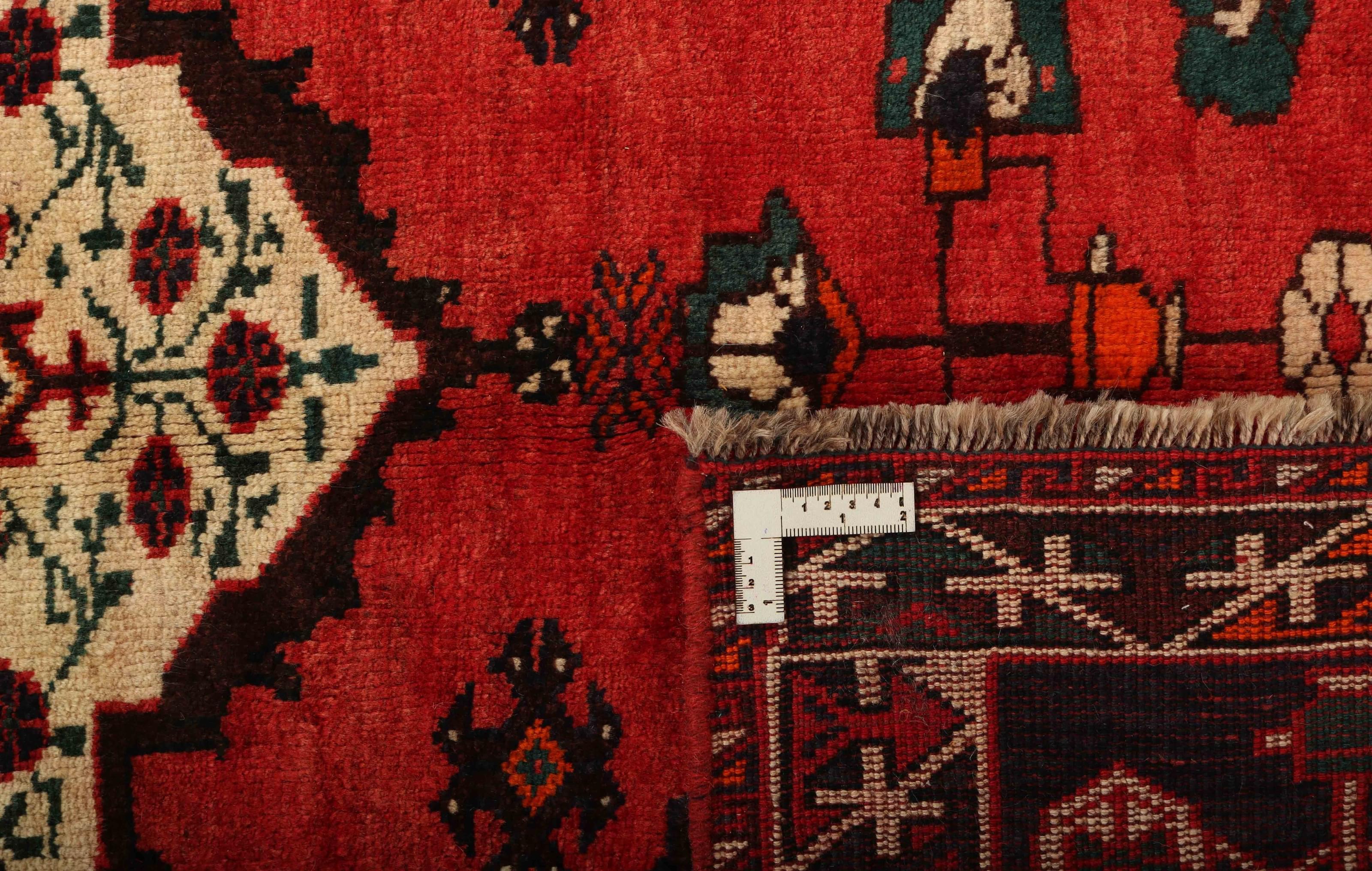 Authentic persian rug with a traditional tribal geometric pattern in red