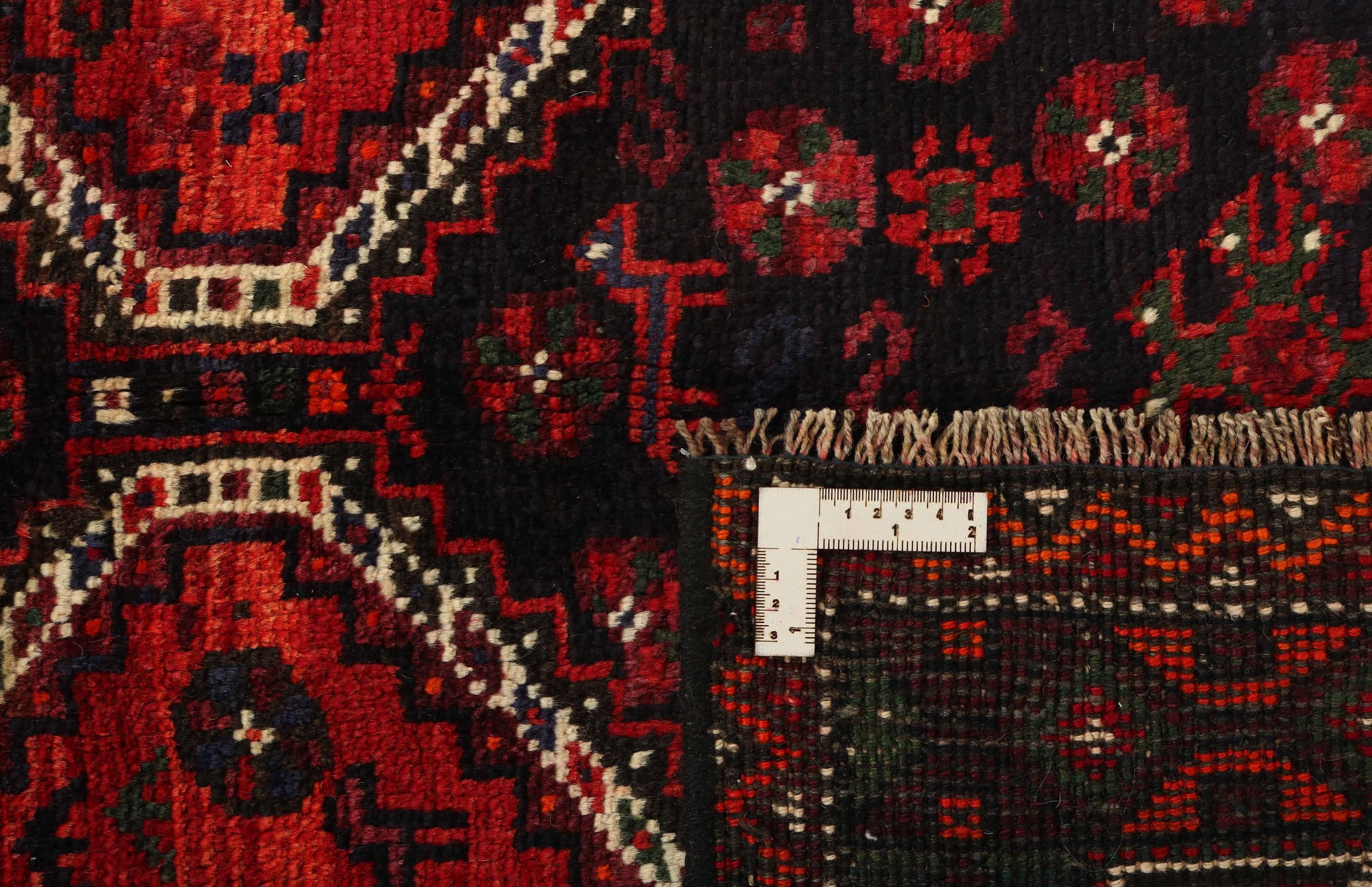 Authentic persian rug with a traditional tribal geometric pattern in red