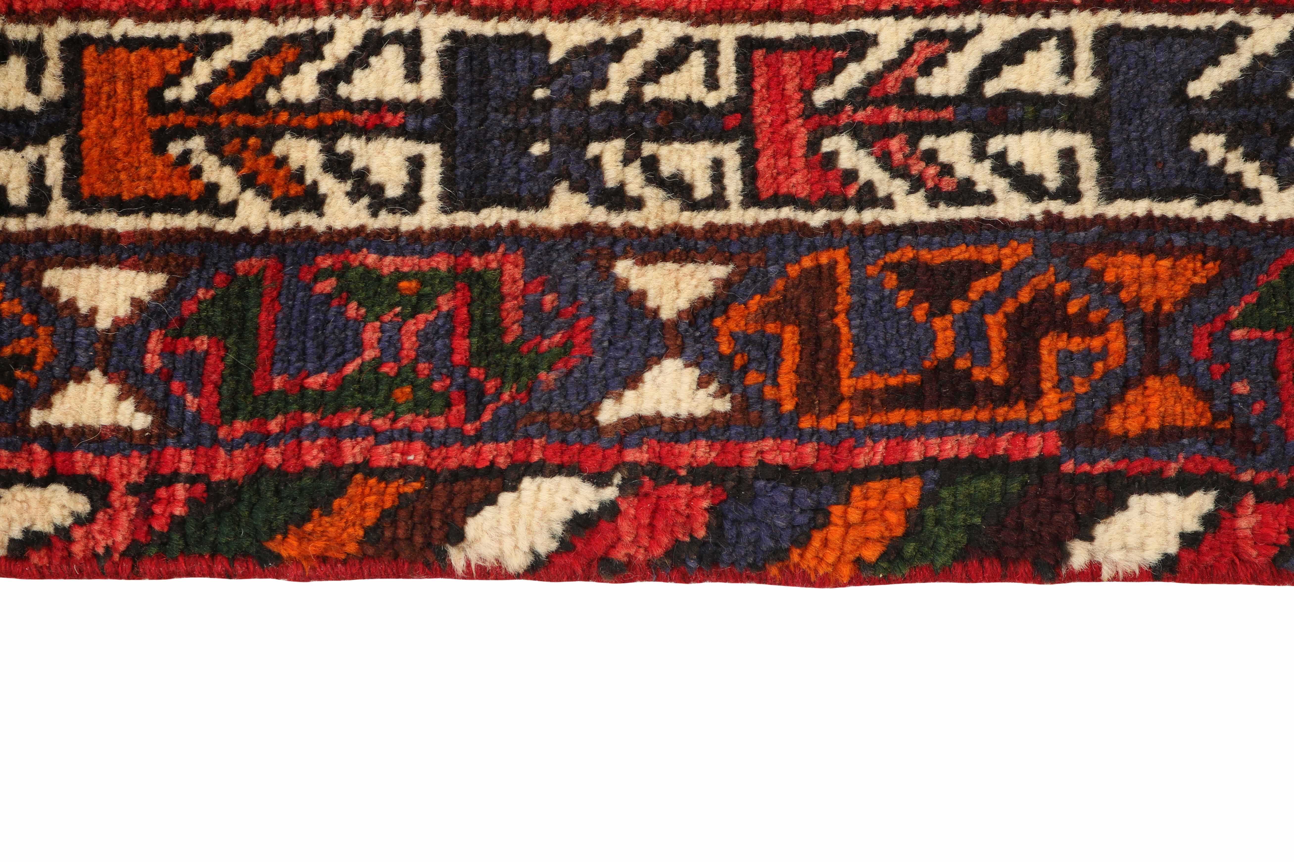 Authentic persian rug with a traditional tribal geometric pattern in red