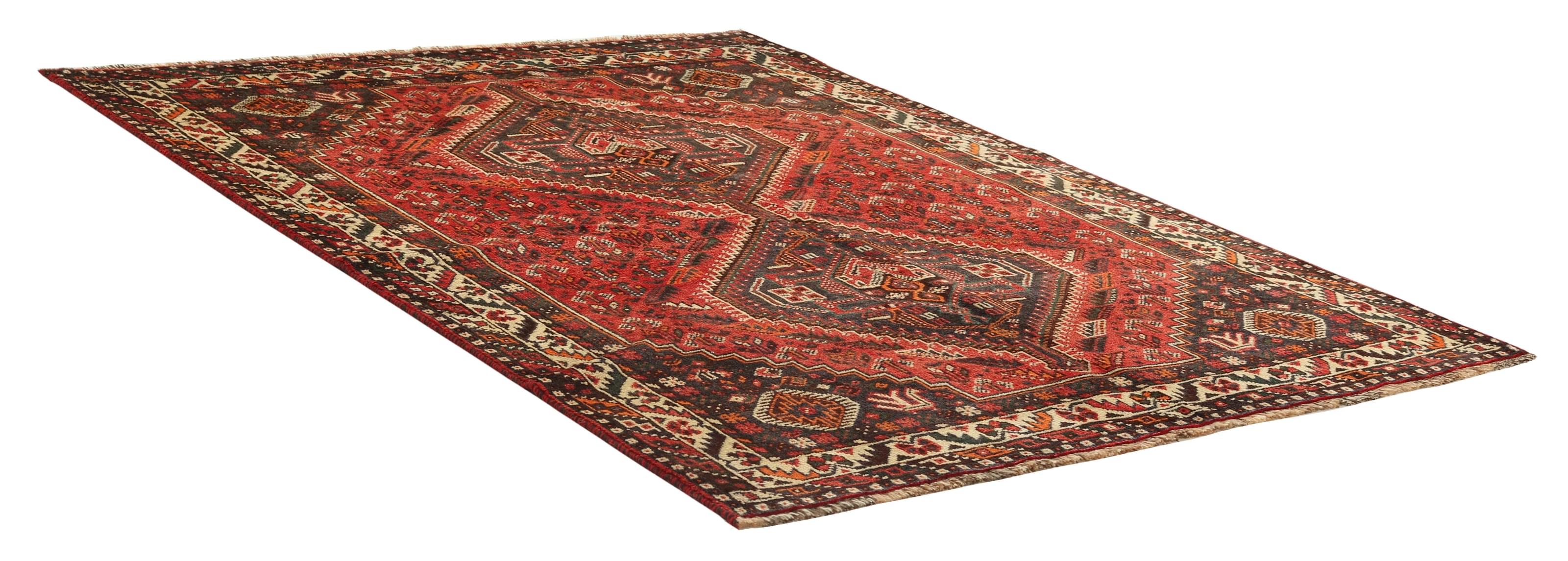 Authentic persian rug with a traditional tribal geometric pattern in red