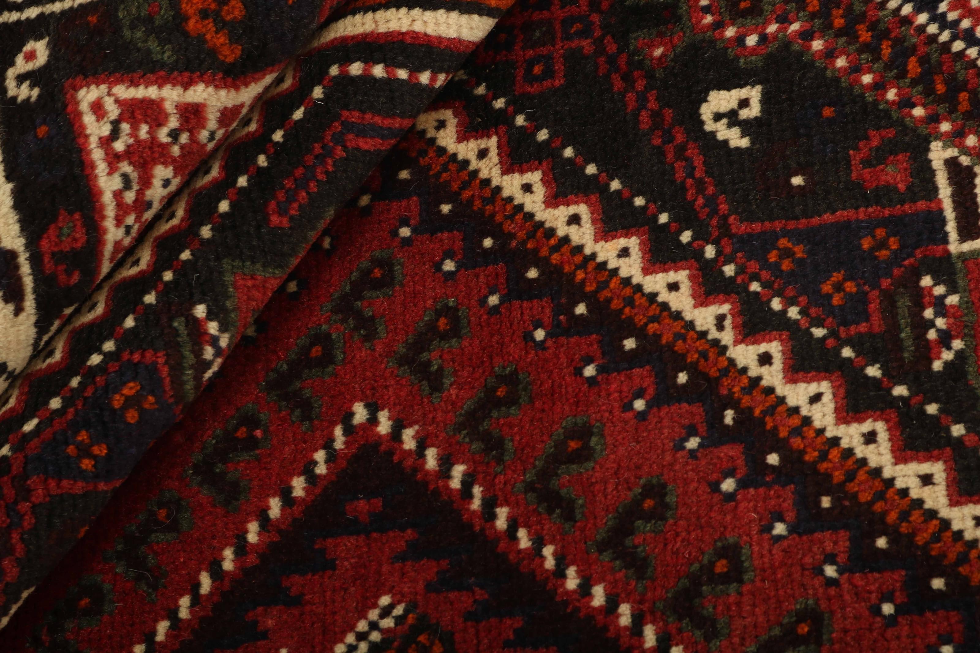 Authentic persian rug with a traditional tribal geometric pattern in red