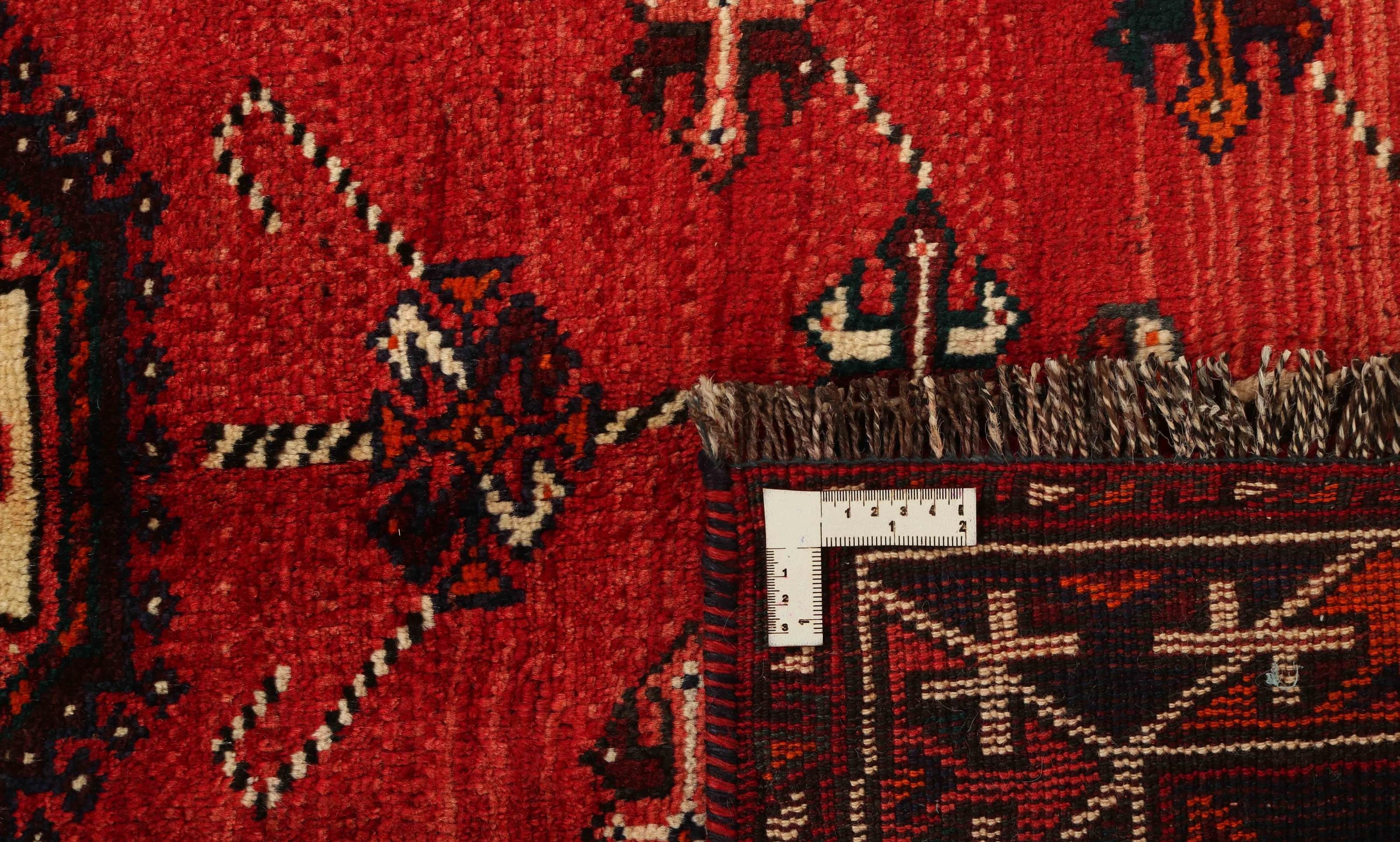 Authentic persian rug with a traditional tribal geometric pattern in red