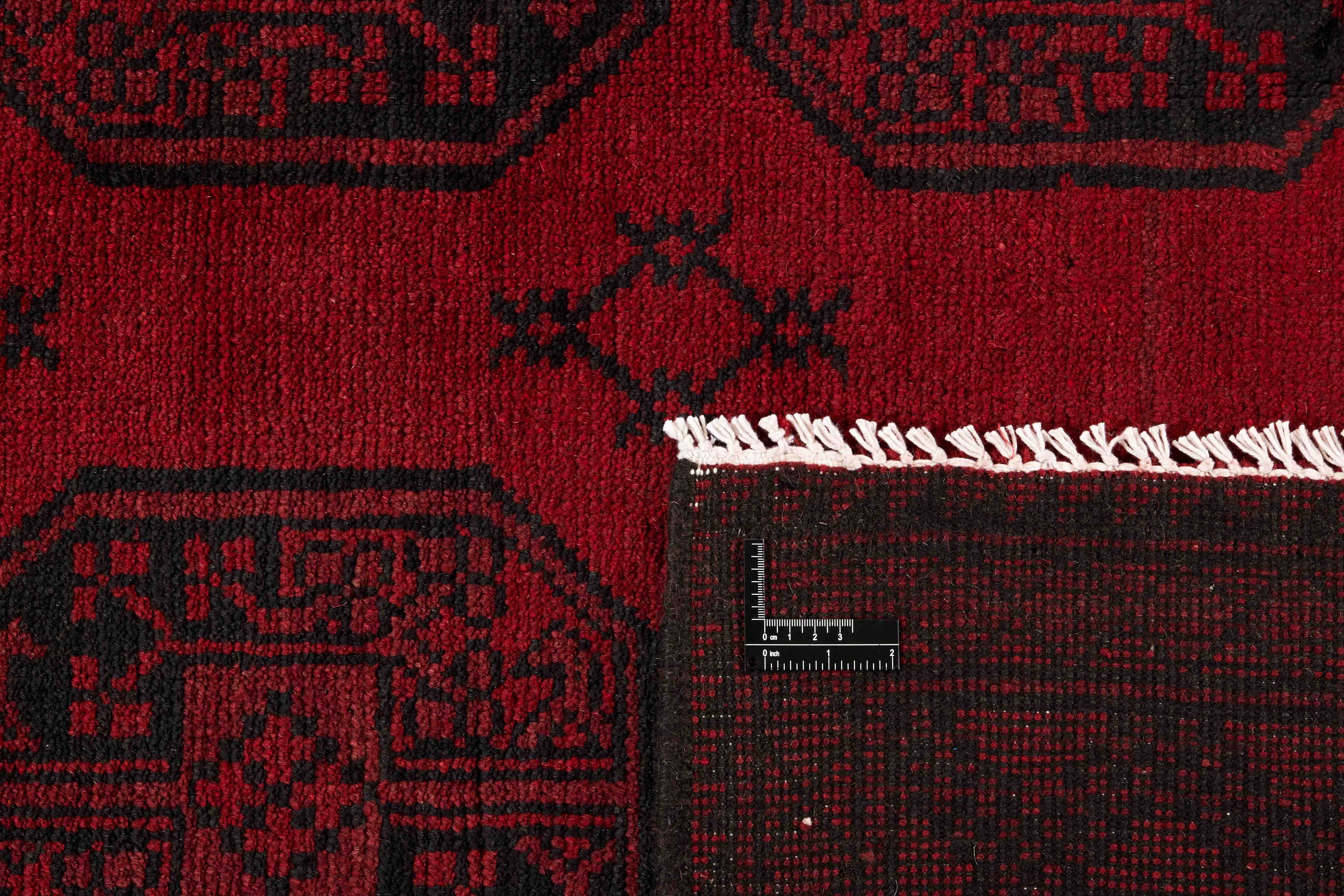 Red oriental rug with traditional elephant's foot pattern