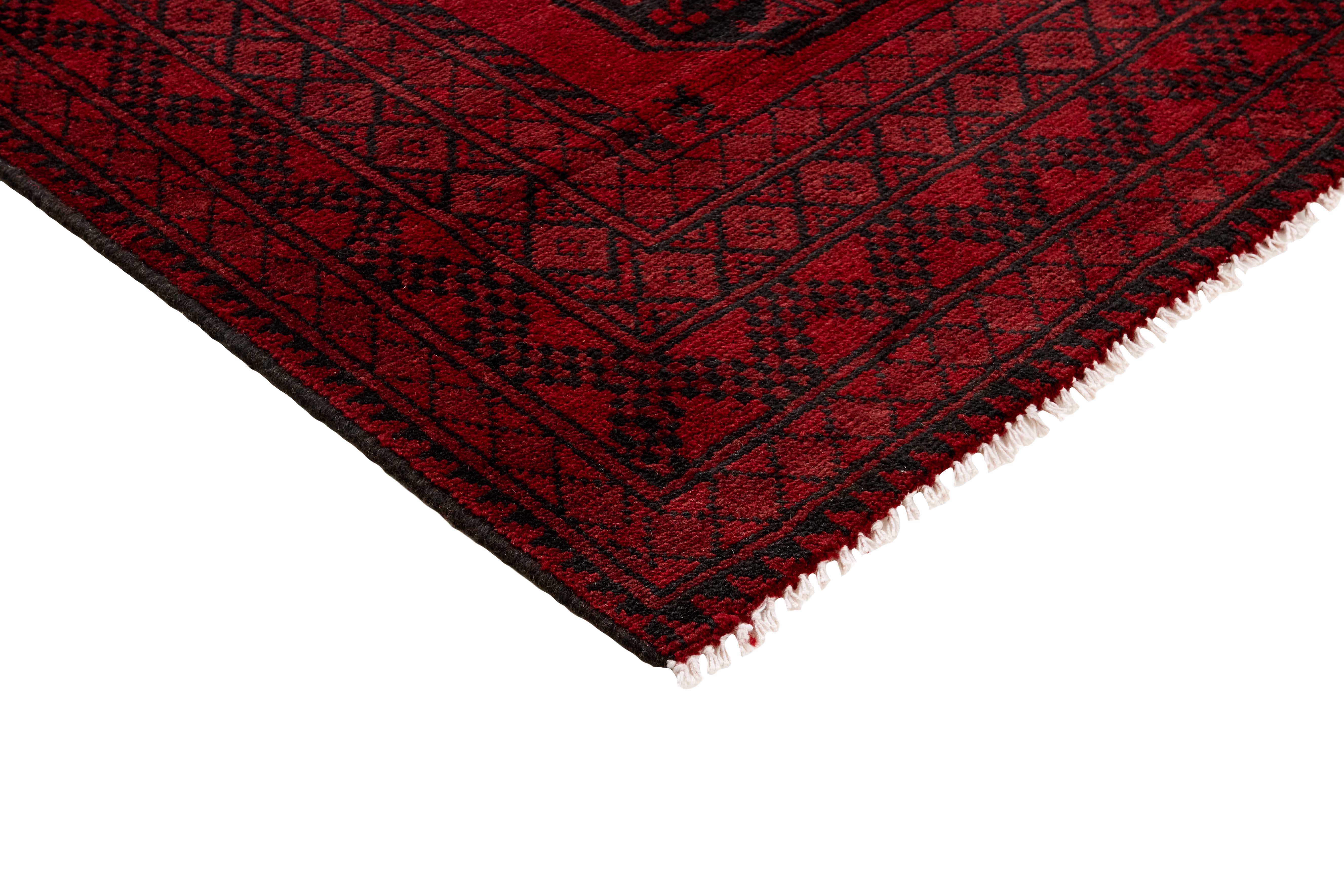 Red oriental rug with traditional elephant's foot pattern