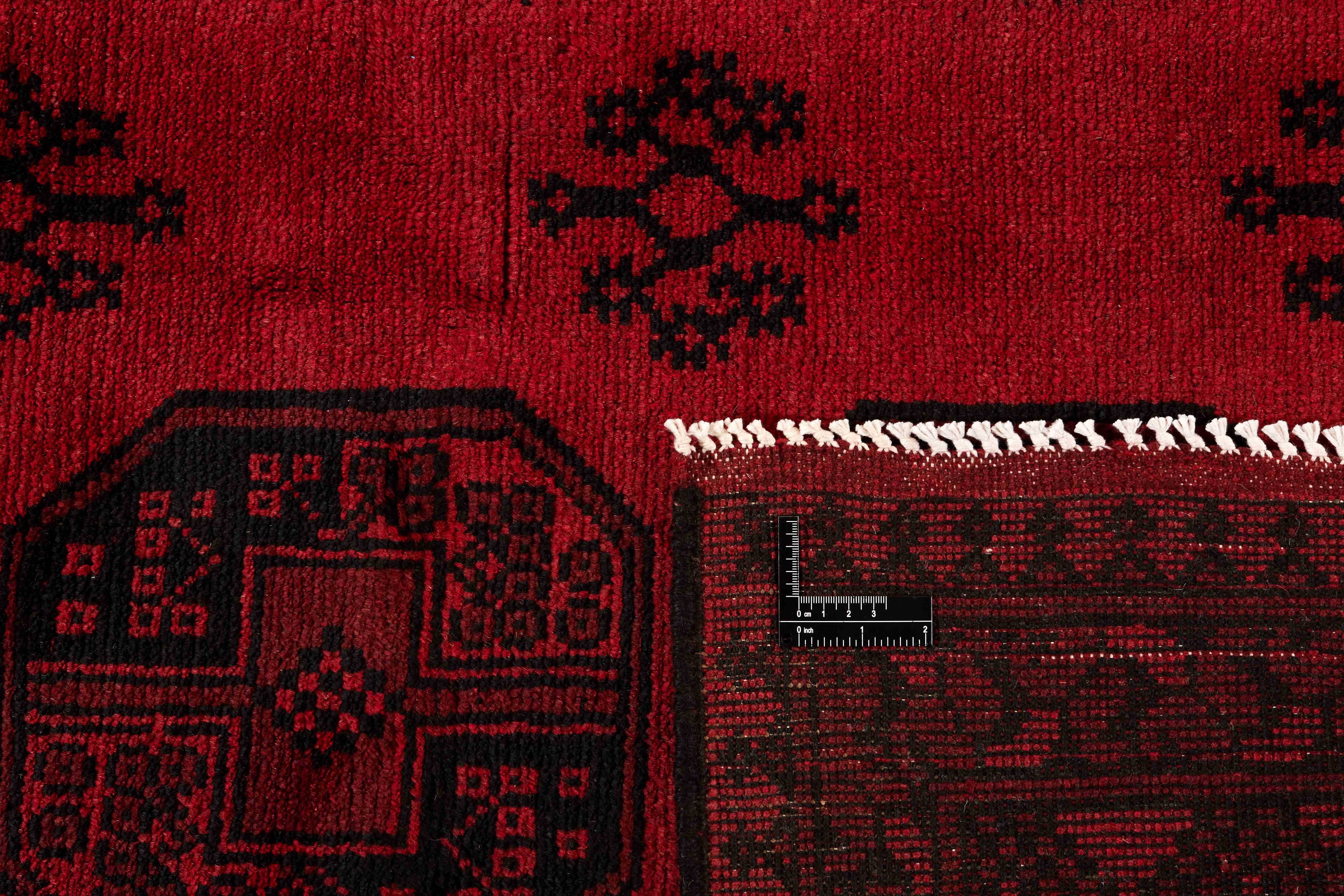 Red oriental rug with traditional elephant's foot pattern