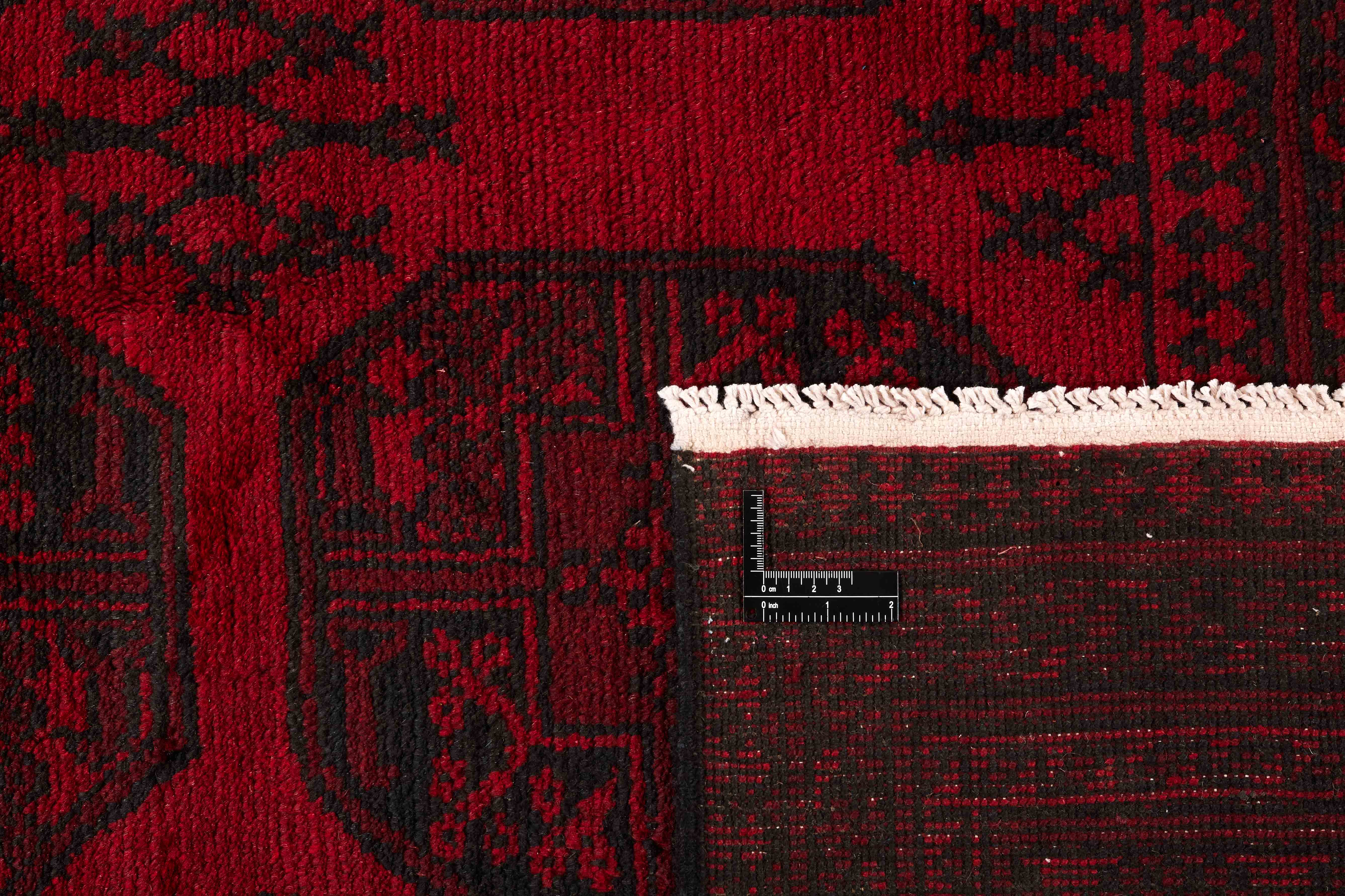 Red oriental rug with traditional elephant's foot pattern