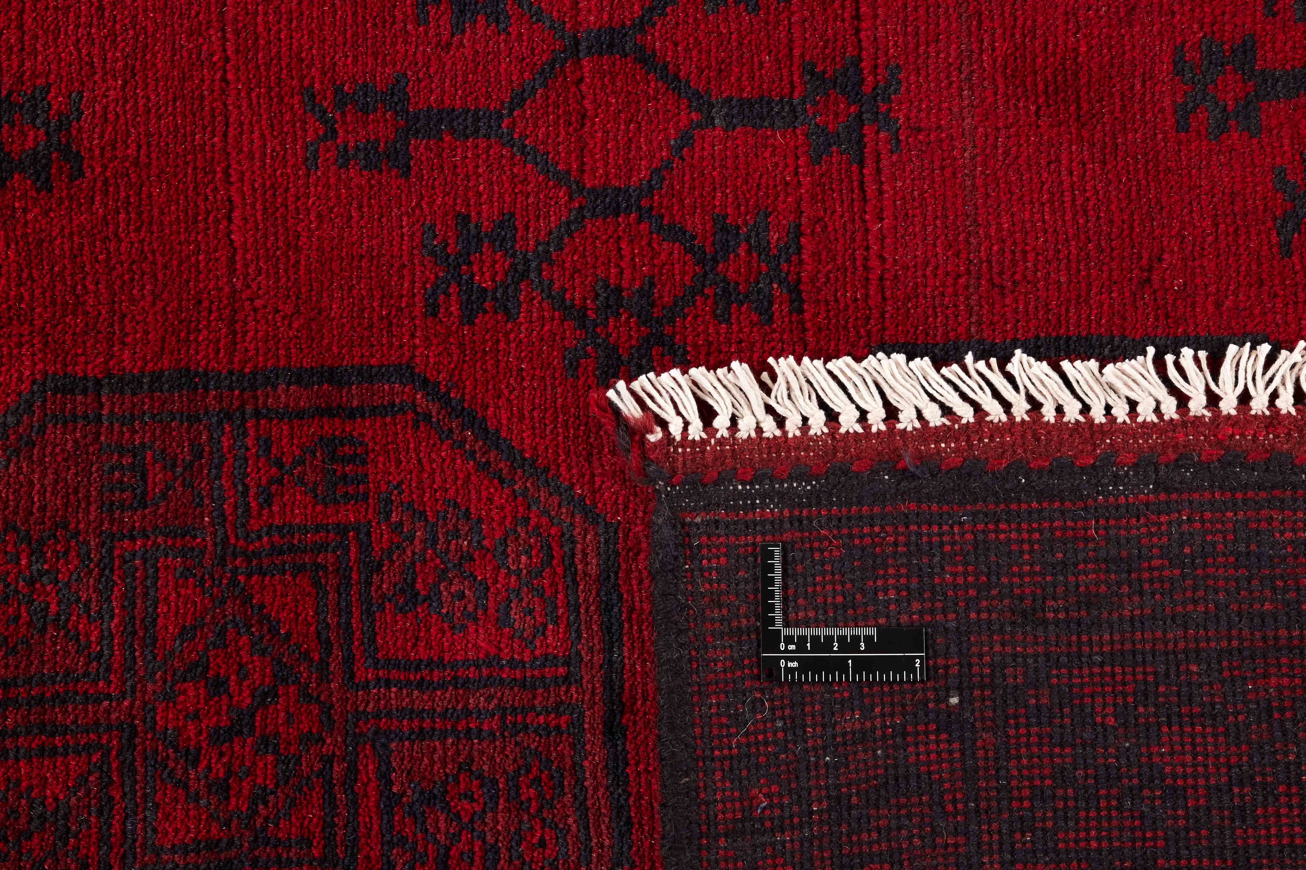 Red oriental rug with traditional elephant's foot pattern
