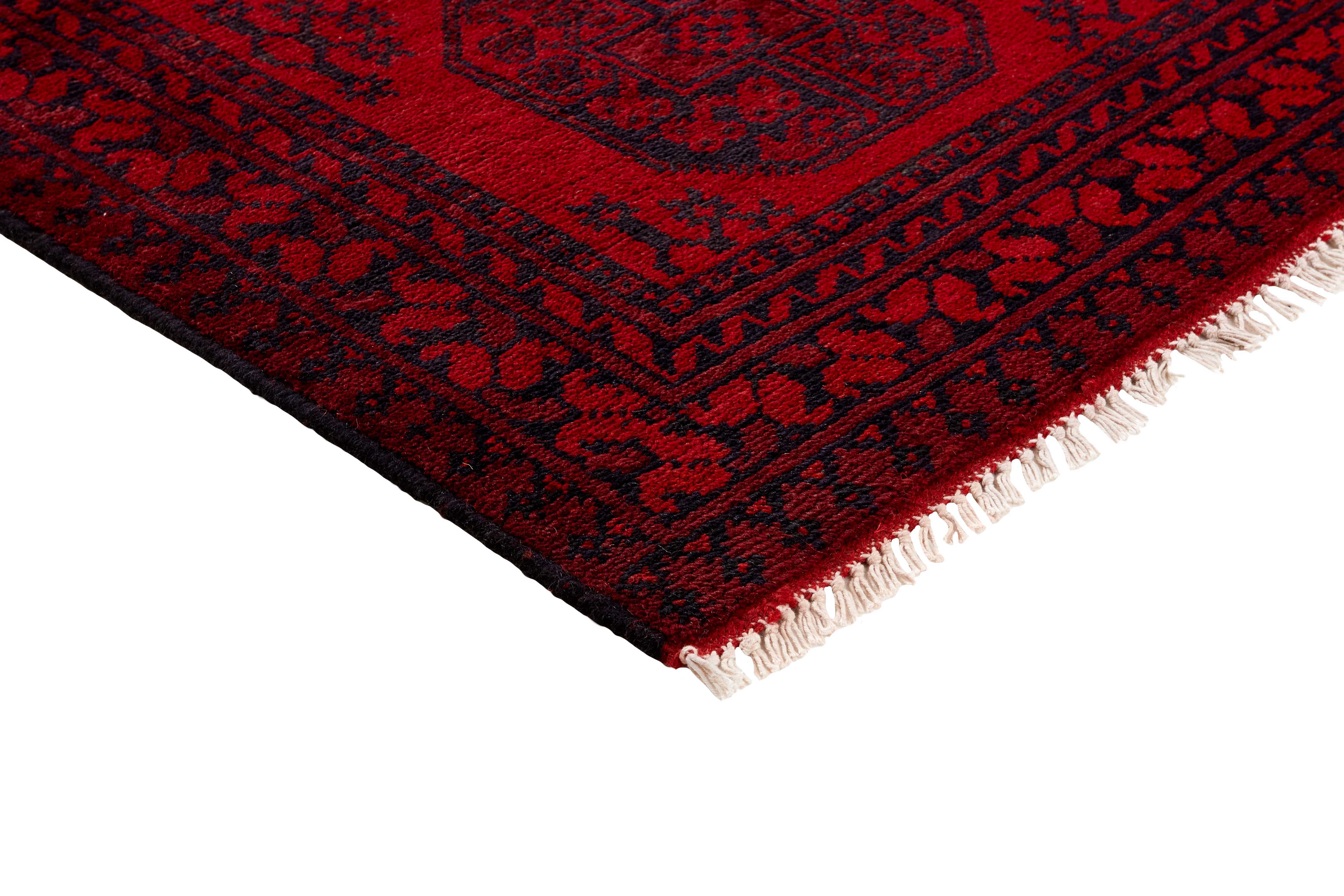 Red Oriental wool runner with a traditional elephant's foot pattern
