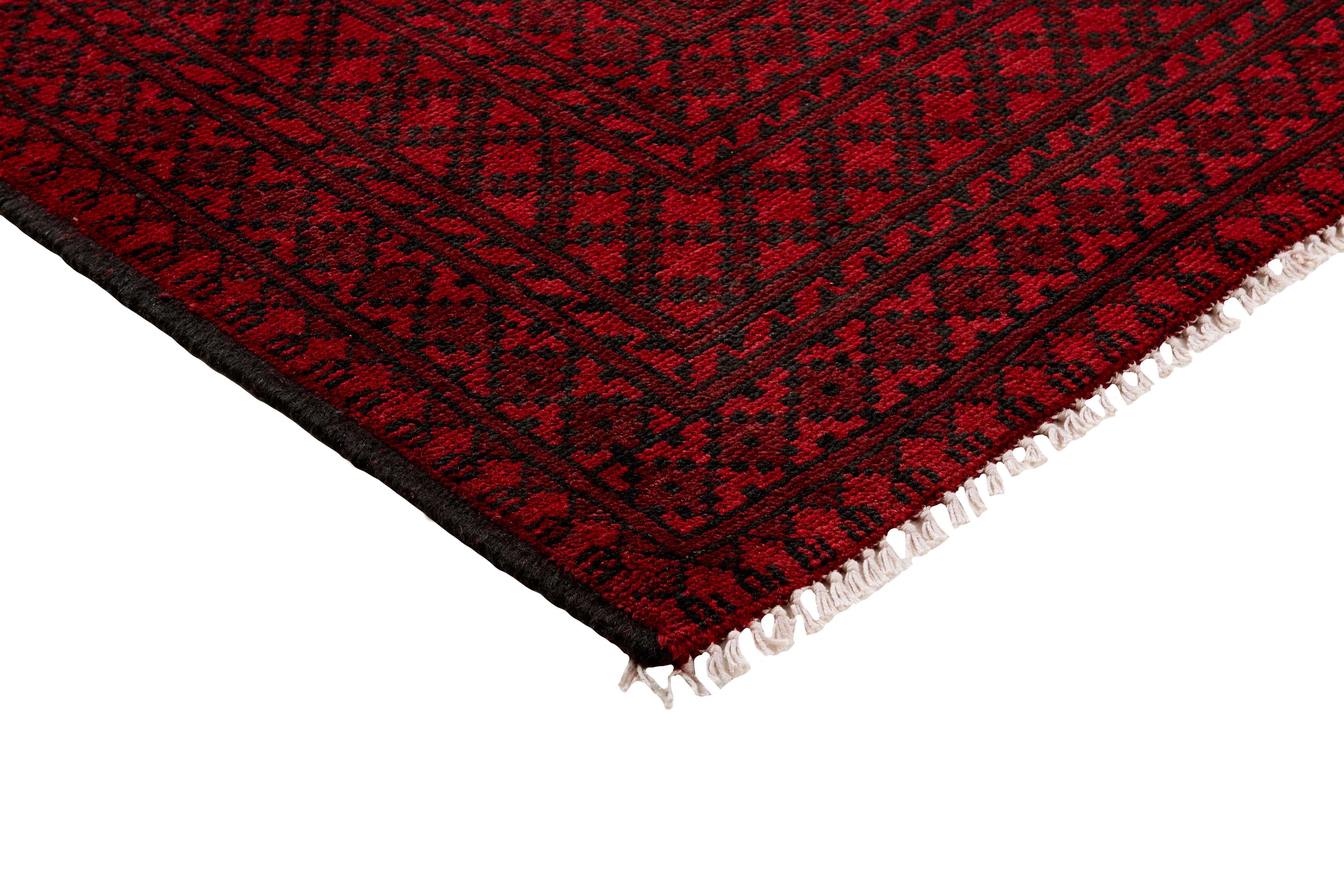 Red oriental rug with traditional elephant's foot pattern