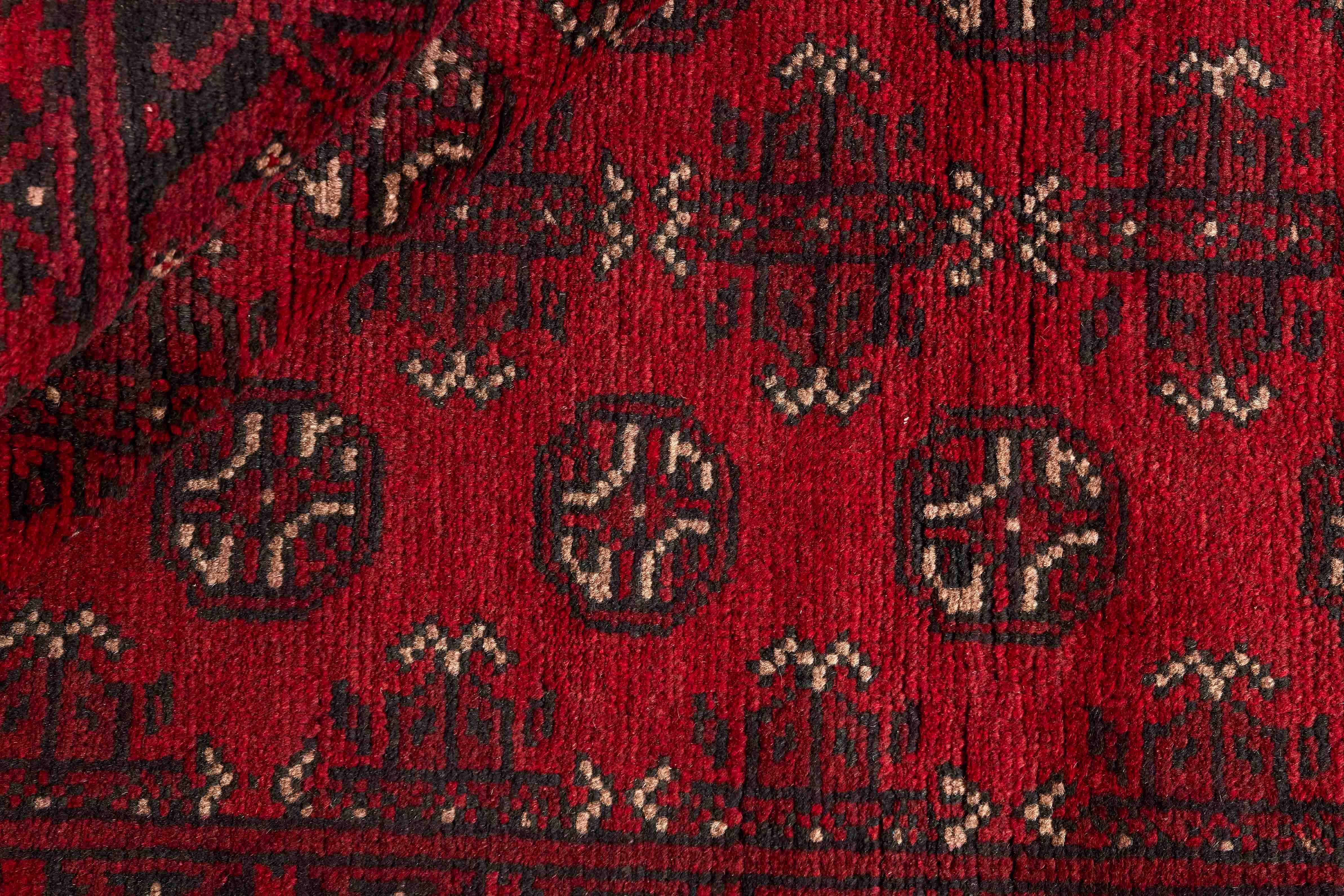 Red oriental rug with traditional elephant's foot pattern