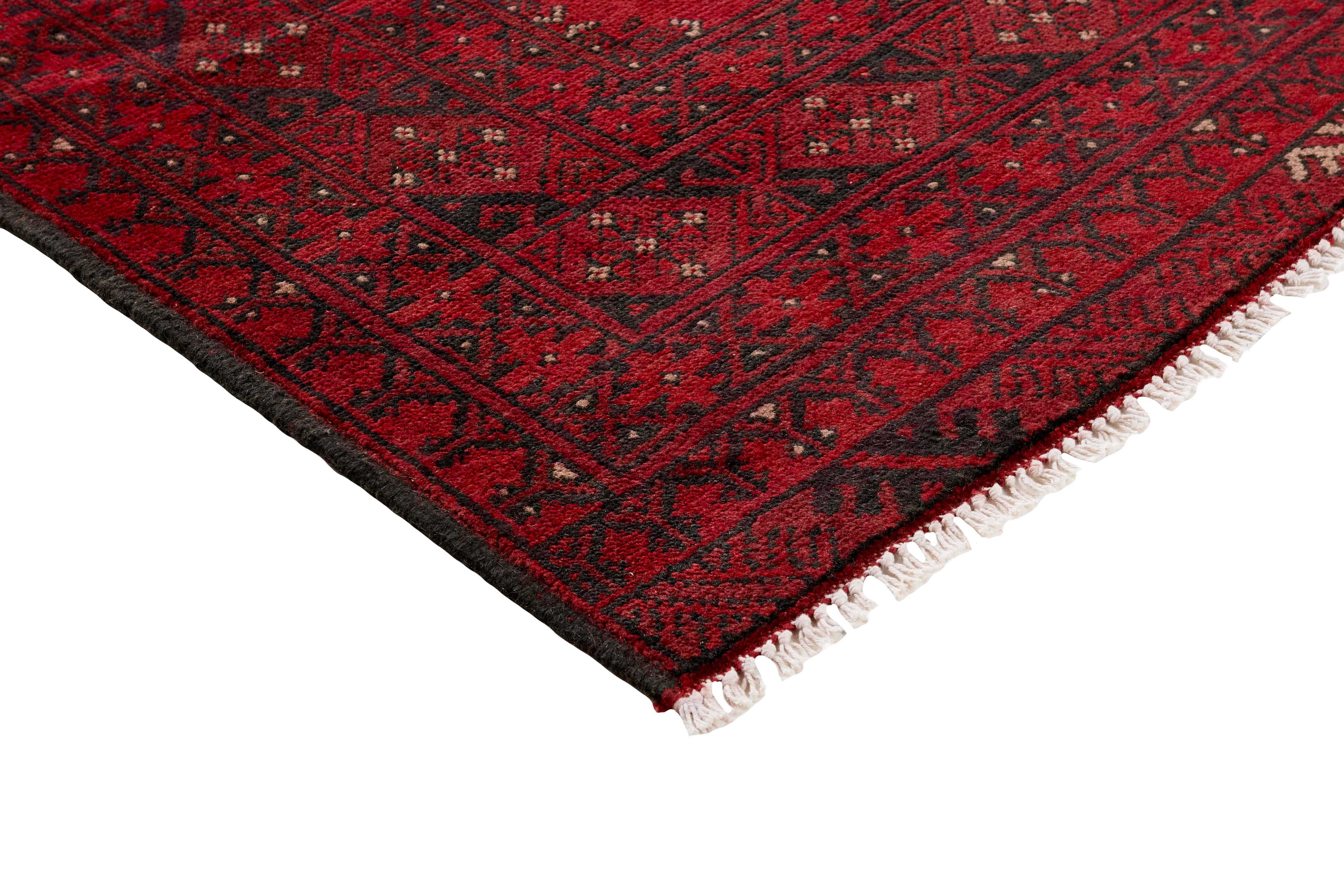 Red oriental rug with traditional elephant's foot pattern